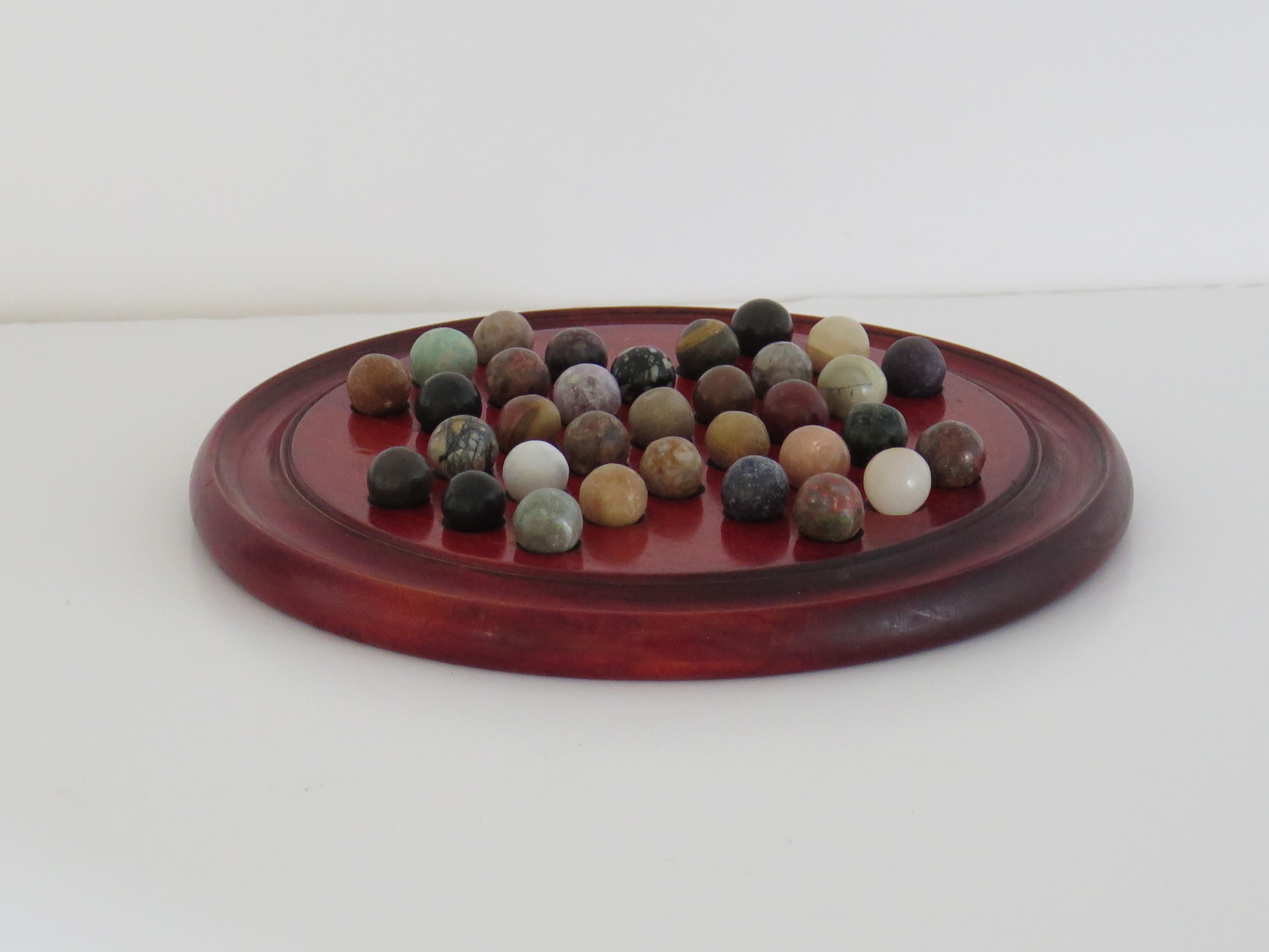 Hand-Crafted Marble Solitaire Game with hardwood board and 33 agate stone Marbles, Circa 1925 For Sale