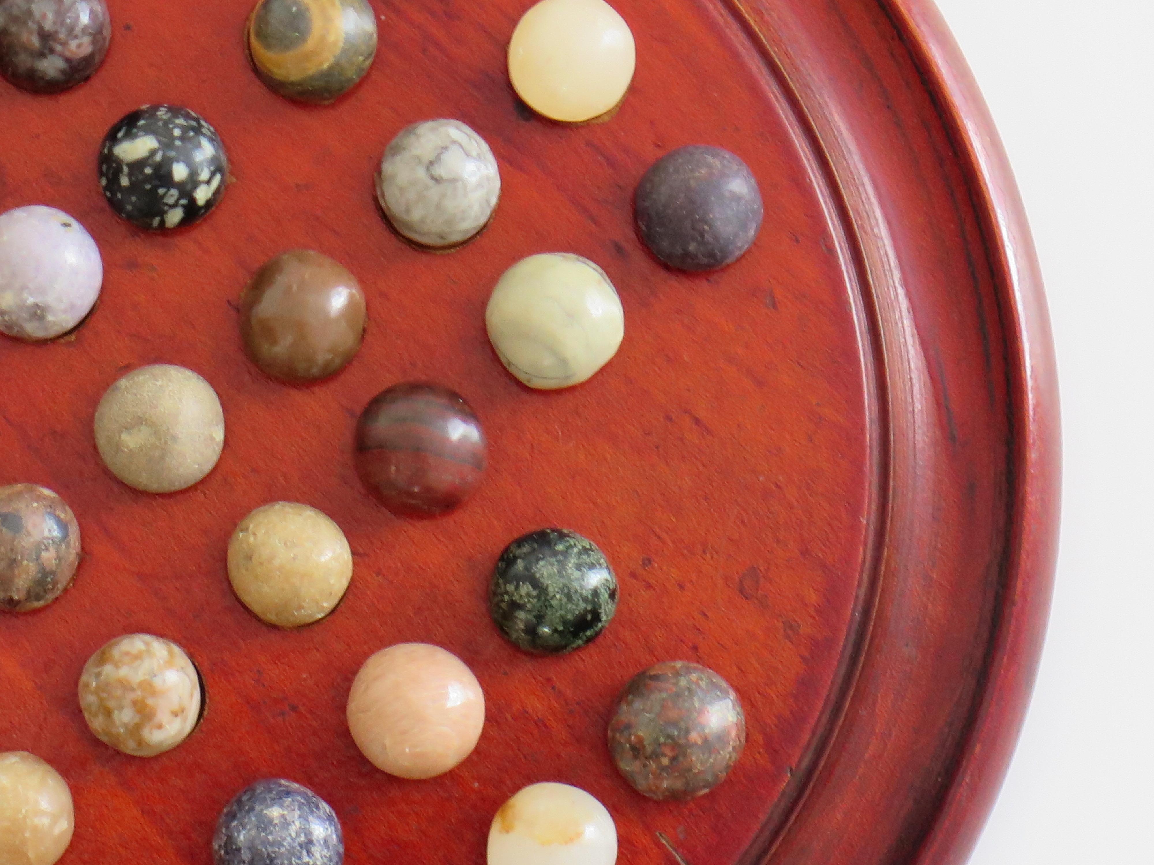 20th Century Marble Solitaire Game with hardwood board and 33 agate stone Marbles, Circa 1925 For Sale