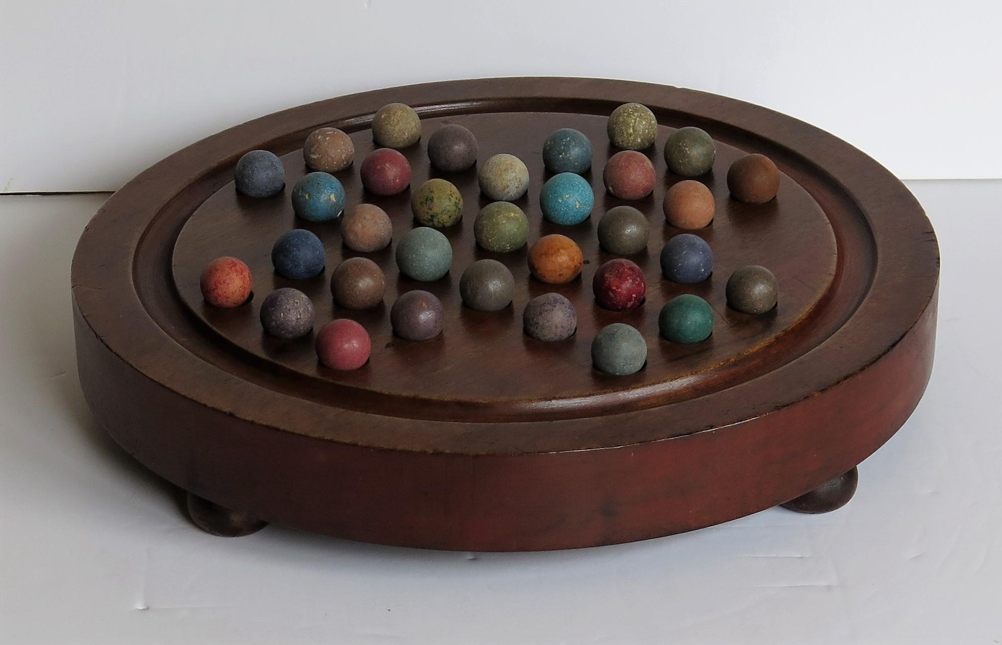 Hand-Crafted Marble Solitaire Hardwood Board with Hanging Ring 33 Clay Marbles, circa 1860