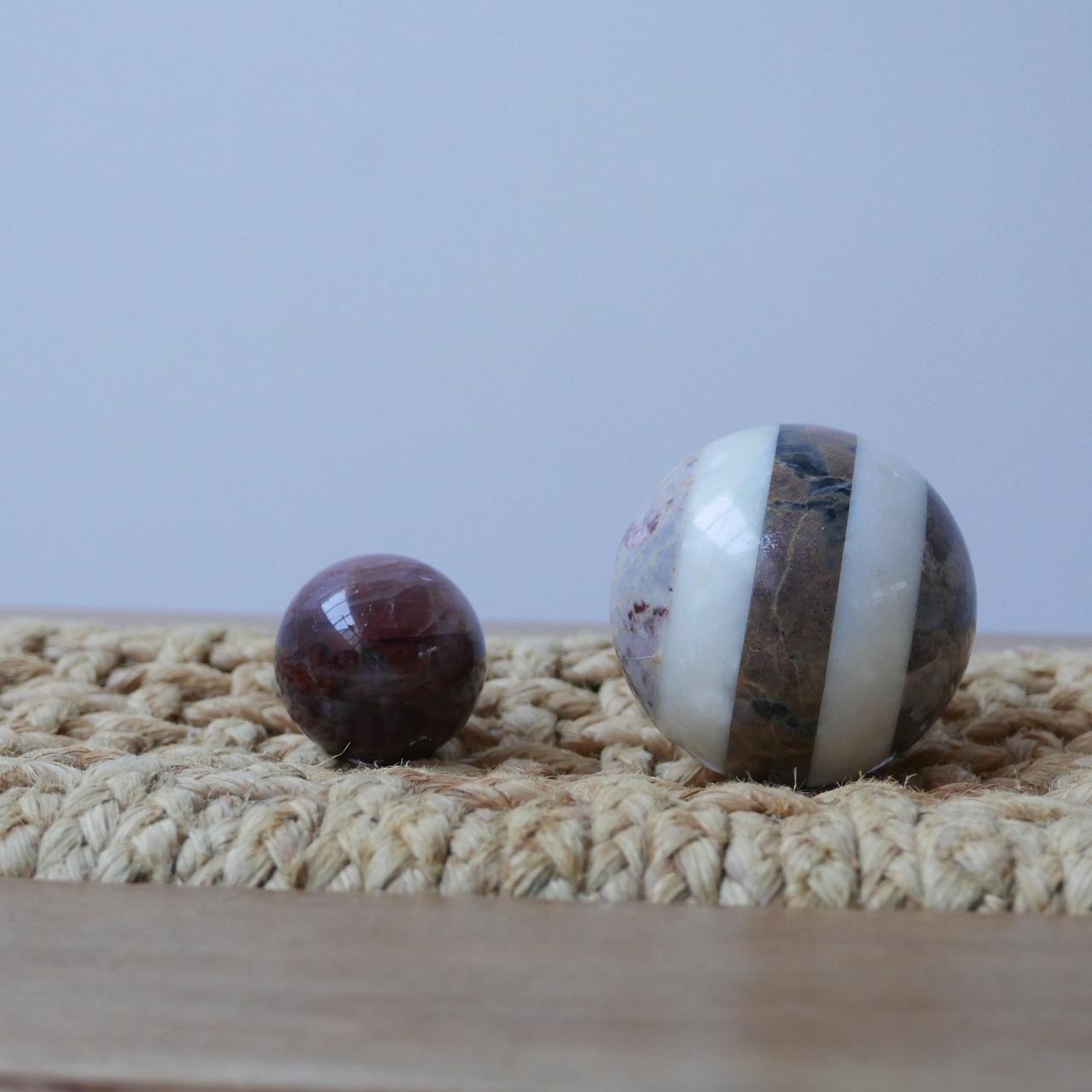 A pair of marble specimen balls.

Simple decorative objects for a shelf or desk top.

Very tactile.

The larger one in particular is made from segmented specimens.

Price is for the pair. 

Dimensions: 10 diameter large, 6 diameter small