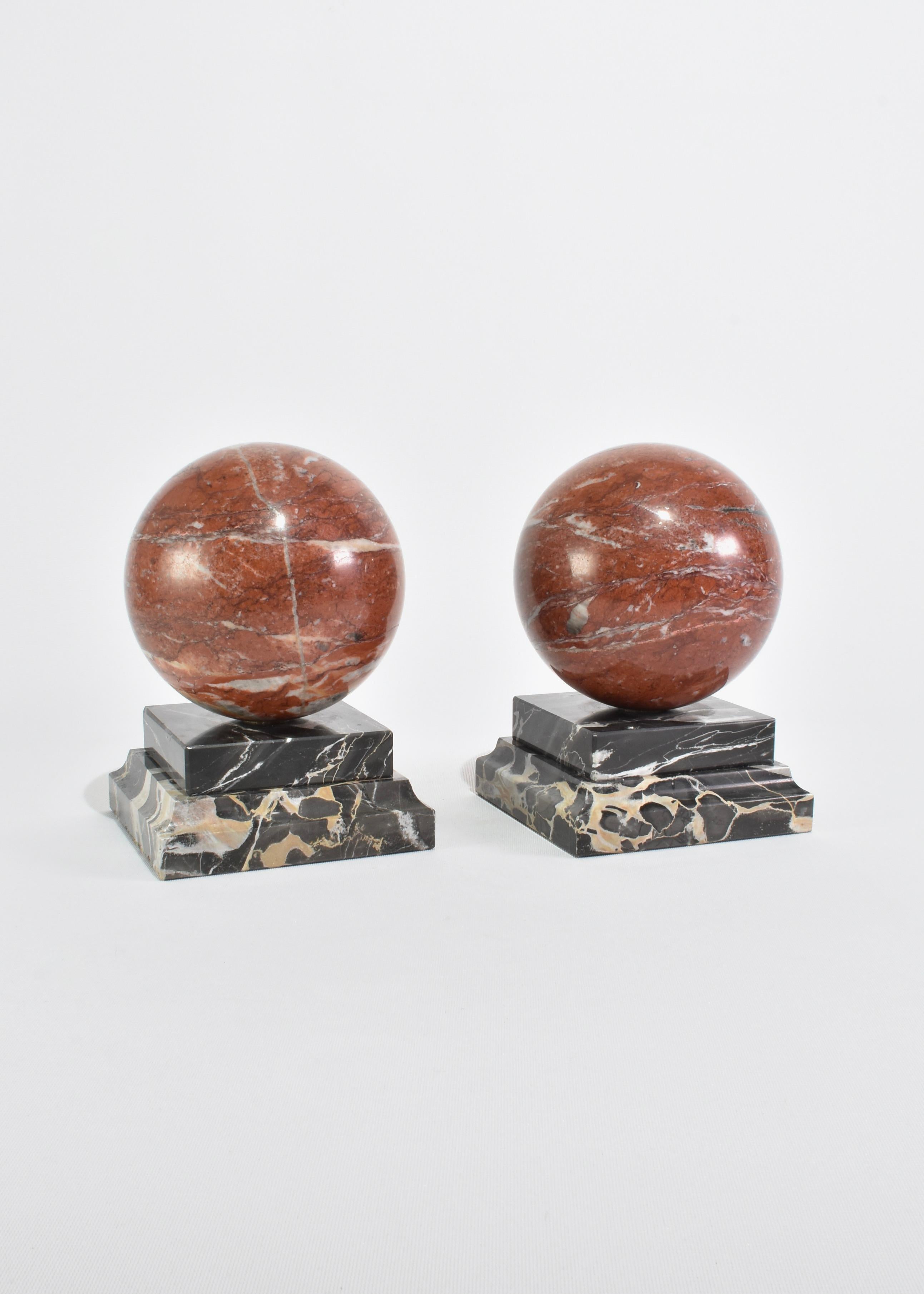 Stunning, large marble sphere bookends connected to a black marble base. C. 1930s.
