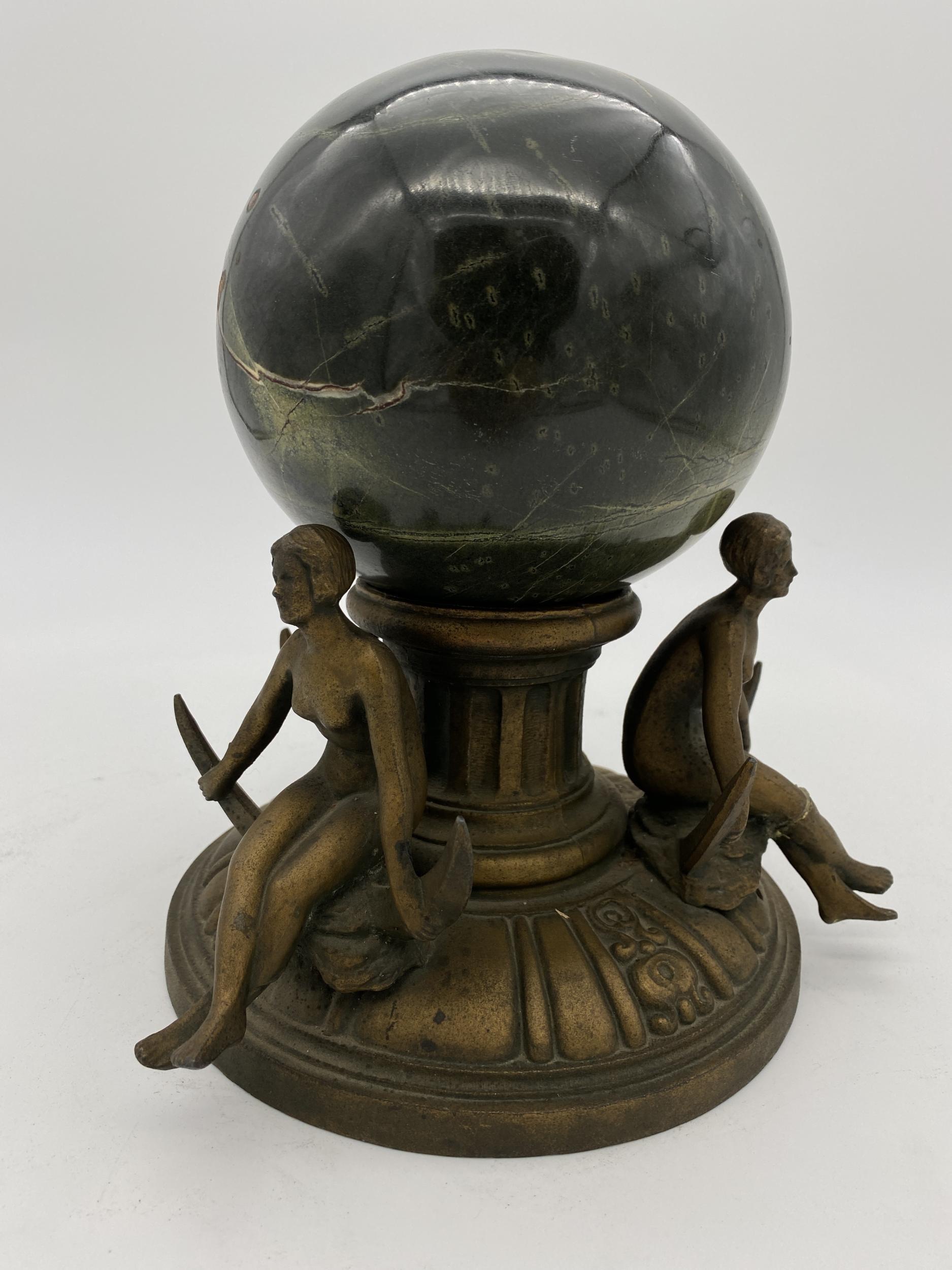 Repurposed Nuart lamp base which has been modified to be a decorative object with a hand carved black Italian sphere. The bronze plate spelter metal base features 3 nude flappers girls sitting on crescent moons fixed to a early Art Deco base.