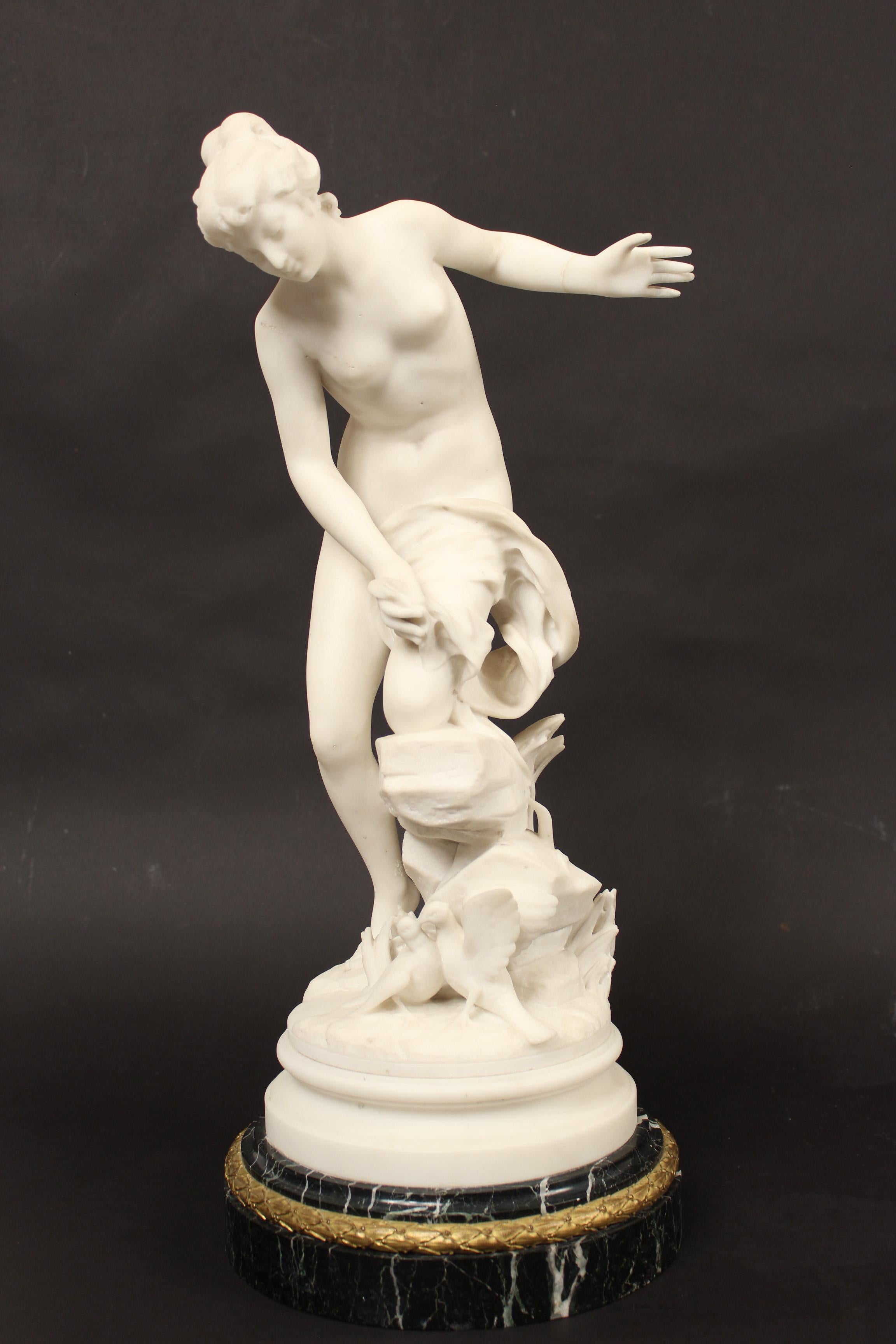 White marble statue of a lady with 2 doves resting on a green marble socle with an ormolu band, signed Rene Bulens, circa 1900. The height of 23