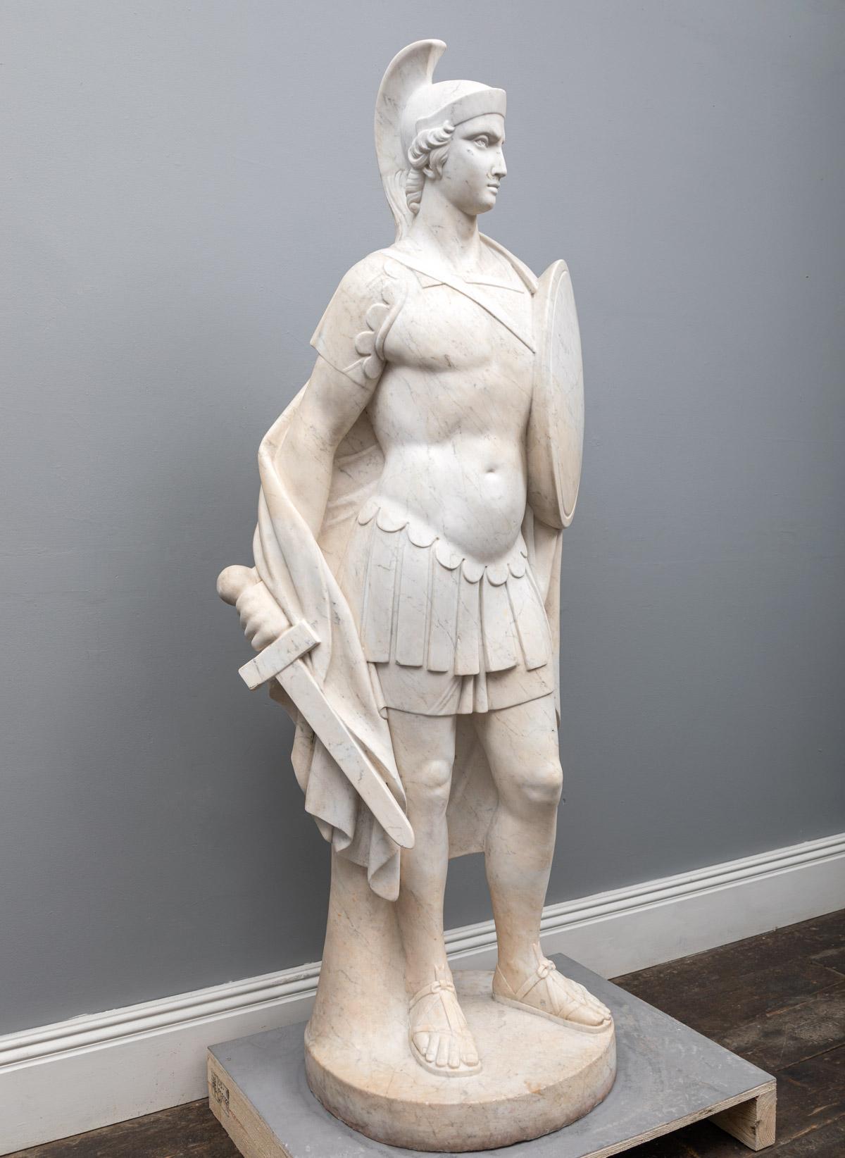 A large (almost life-sized) antique Carrara marble statue of a Roman legionary. Dressed in typical Roman soldier costume and with sword and shield in hand.


 