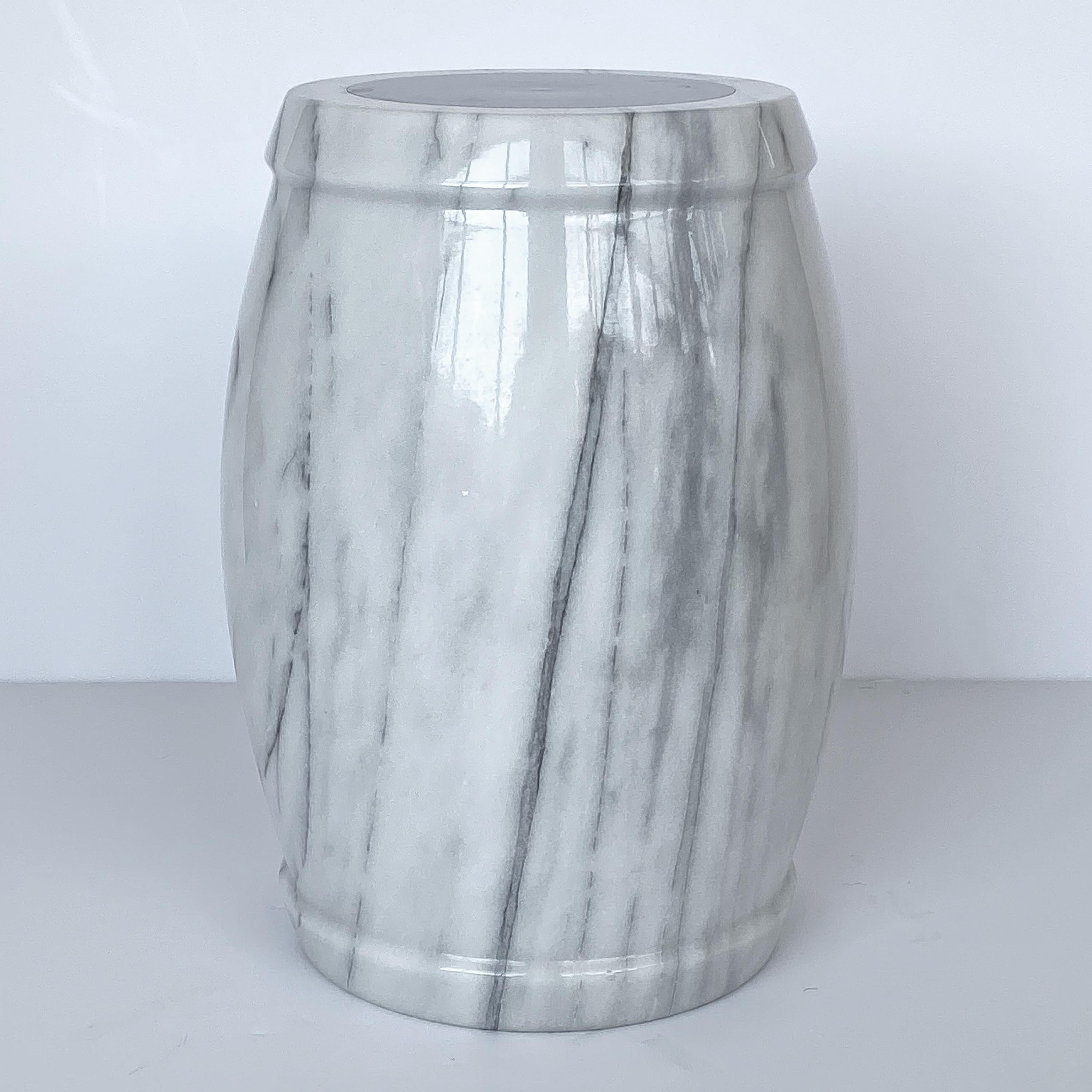 A unique marble stool or side table. White marble with gray veining. Top is inset with a round 7