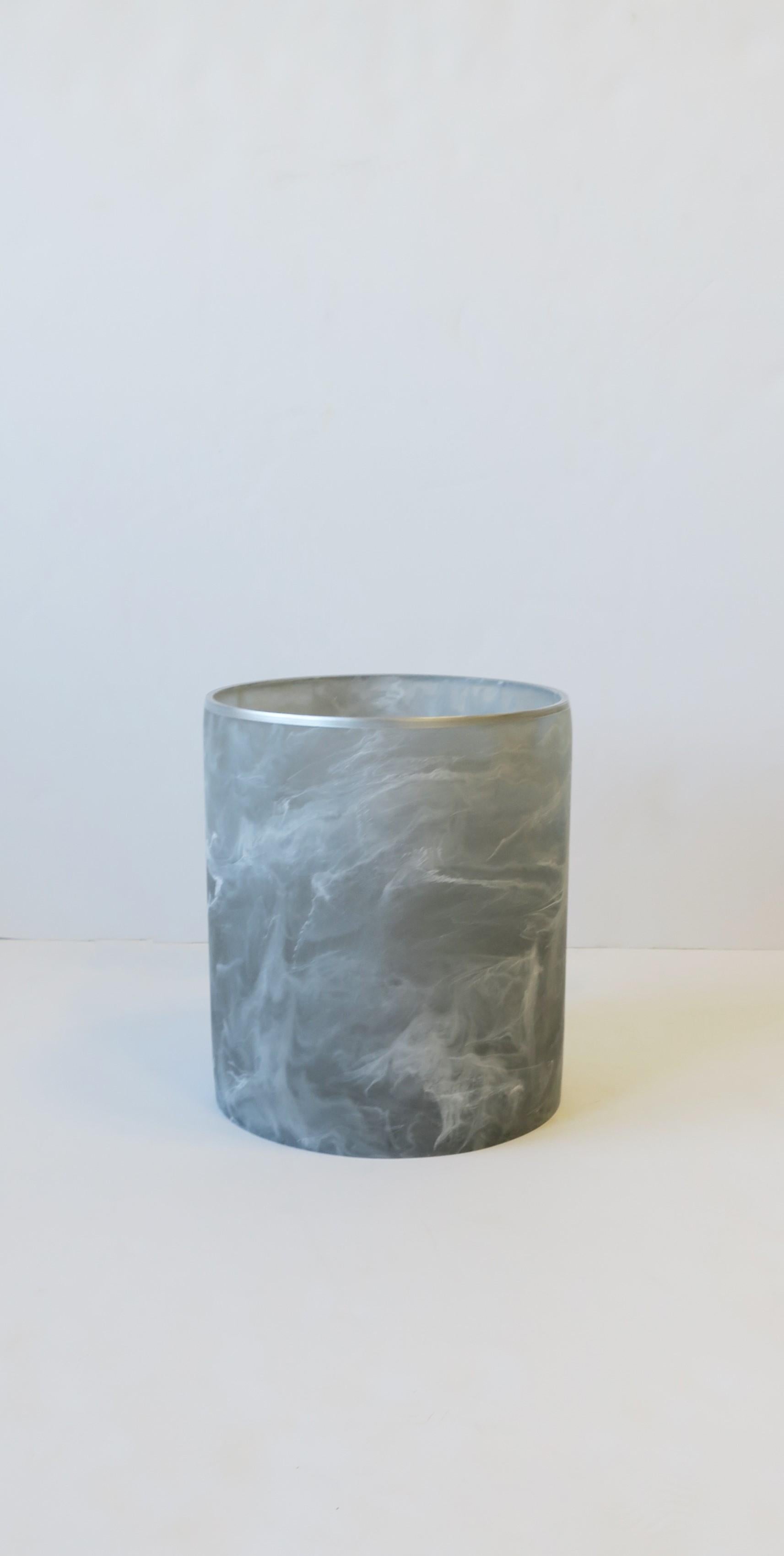 A marble style acrylic wastebasket [waste basket] or trash can in grey and white. Wastebasket is a matte acrylic with a marble-like design. A great piece for a home office, bathroom, walk-in-closet area, etc. Dimensions: 8