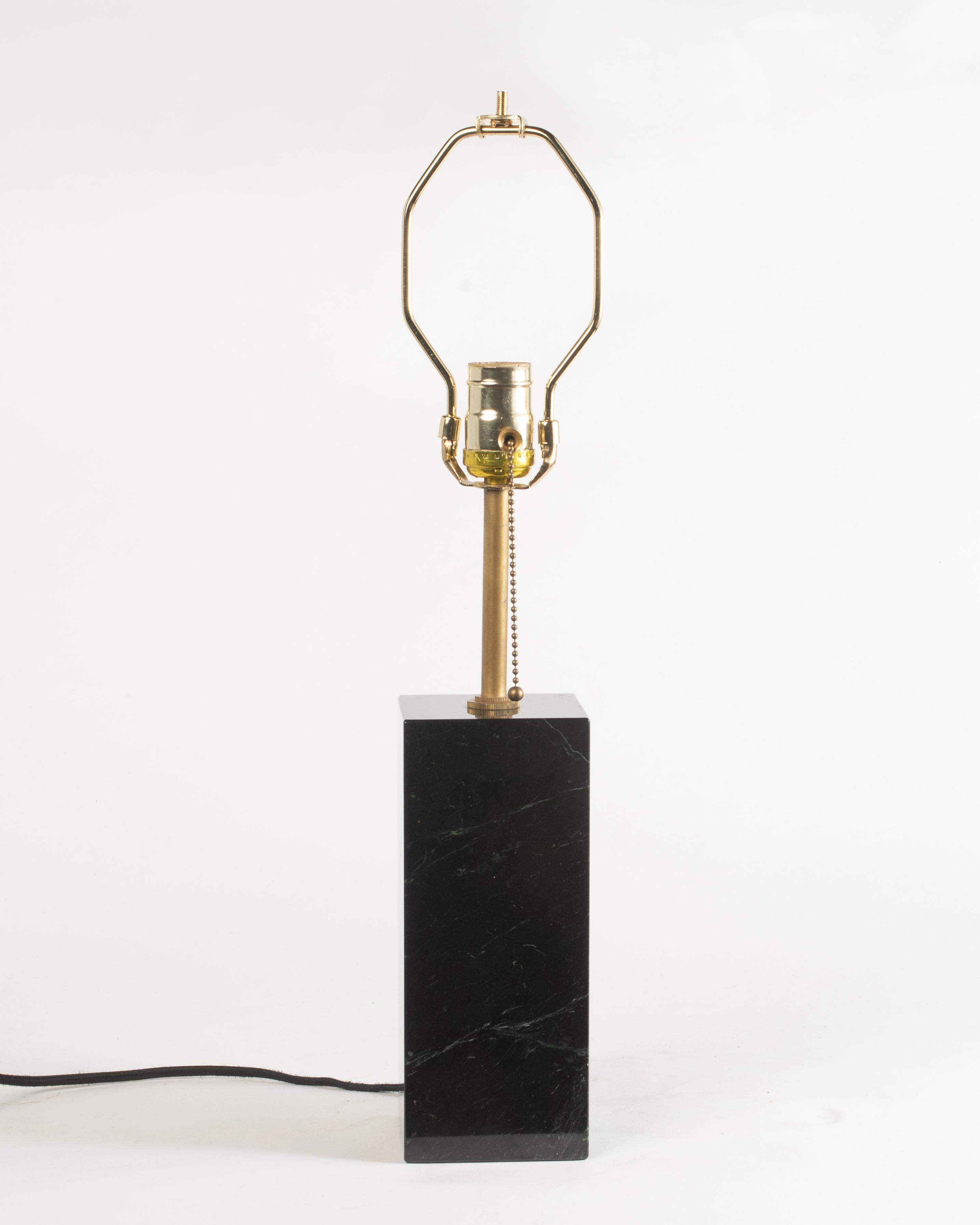 A wonderful petite table lamp after T.H. Robsjohn-Gibbings for Hansen, New York. Well-chosen piece of black marble with faint white and green veining. Dimensions: 15
