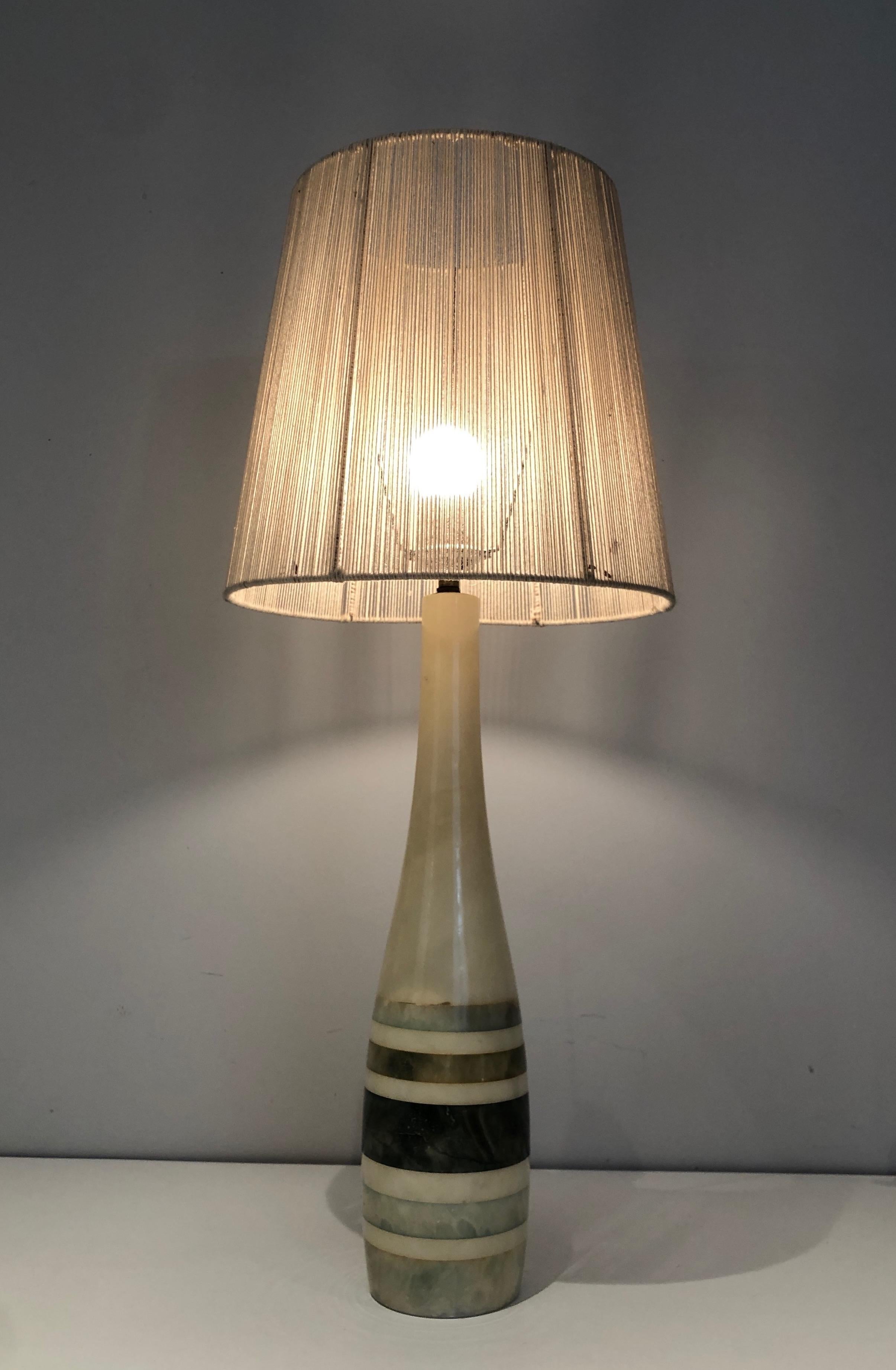 This very nice table lamp is made of marble with colored marble incrustations. This is a French work. Circa 1970.