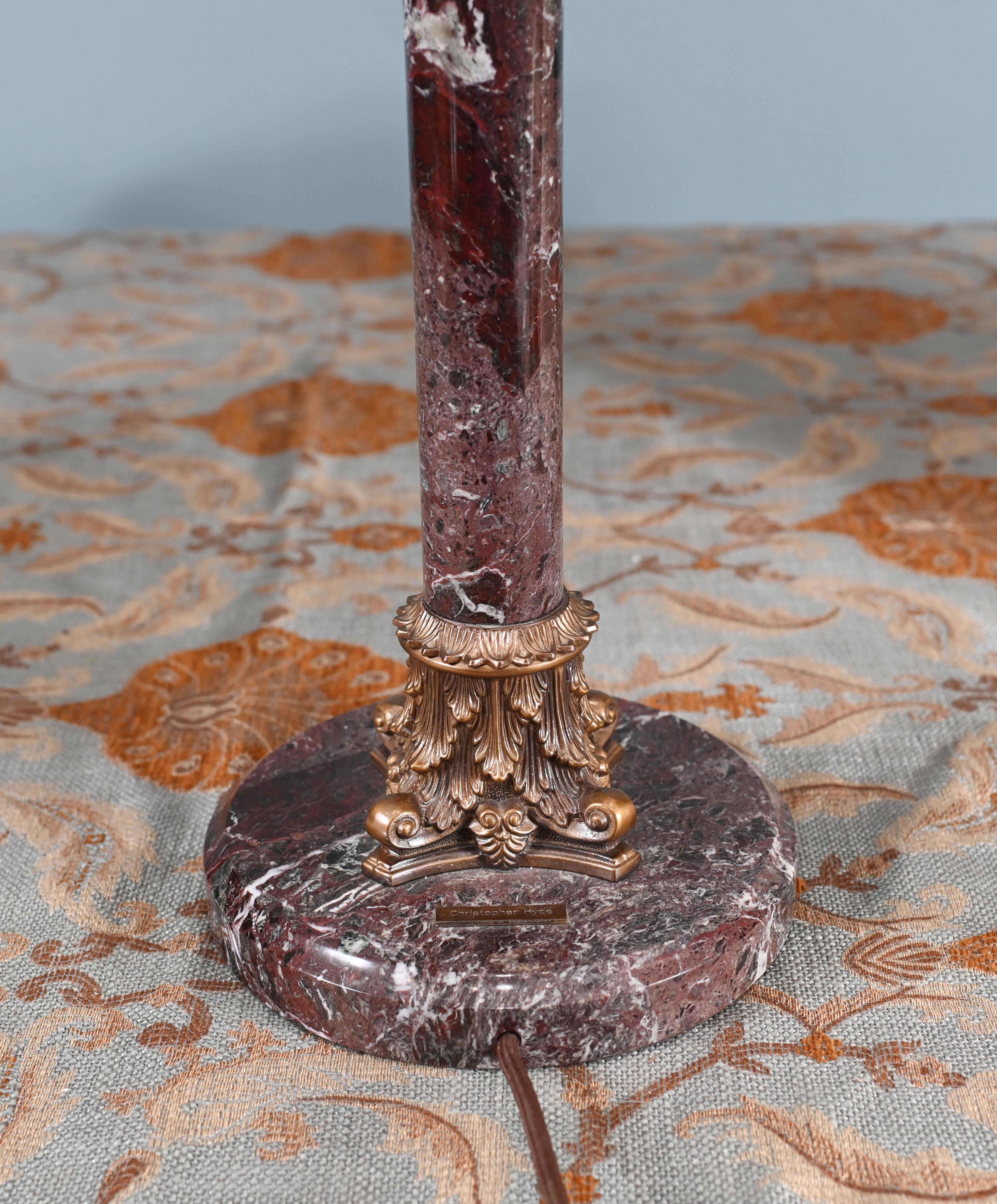 You are viewing a refined marble lamp in the form of a Corinthian column
Lovely colour to the red marble complemented by gilt fixtures
Lamp is by Christopher Hyde - please see makers stamp close up photo Bought from a private house sale in London's