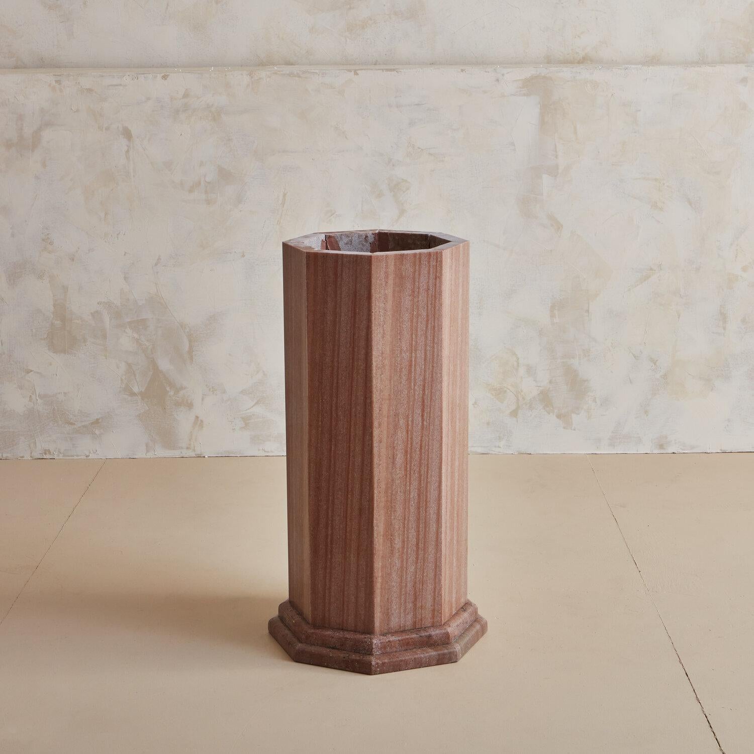 A stunning marble dining or entryway table with a round top resting on a hexagonal mitered edge base with a banded-edge detail. The marble is a gorgeous rust color with brown and red tones featuring straight vertical veins. 

Dimensions: 30”