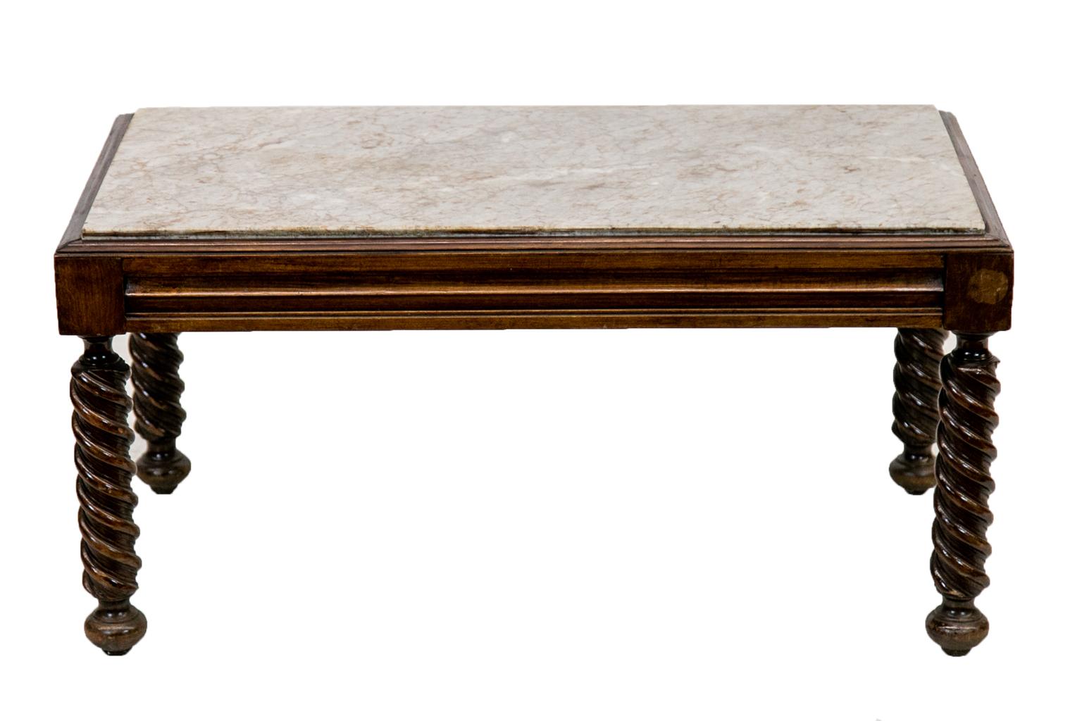The top of this coffee table has shaped applied molding. There are shaped molded panels in the apron on all four sides. The marble is not attached but sits securely in the frame.