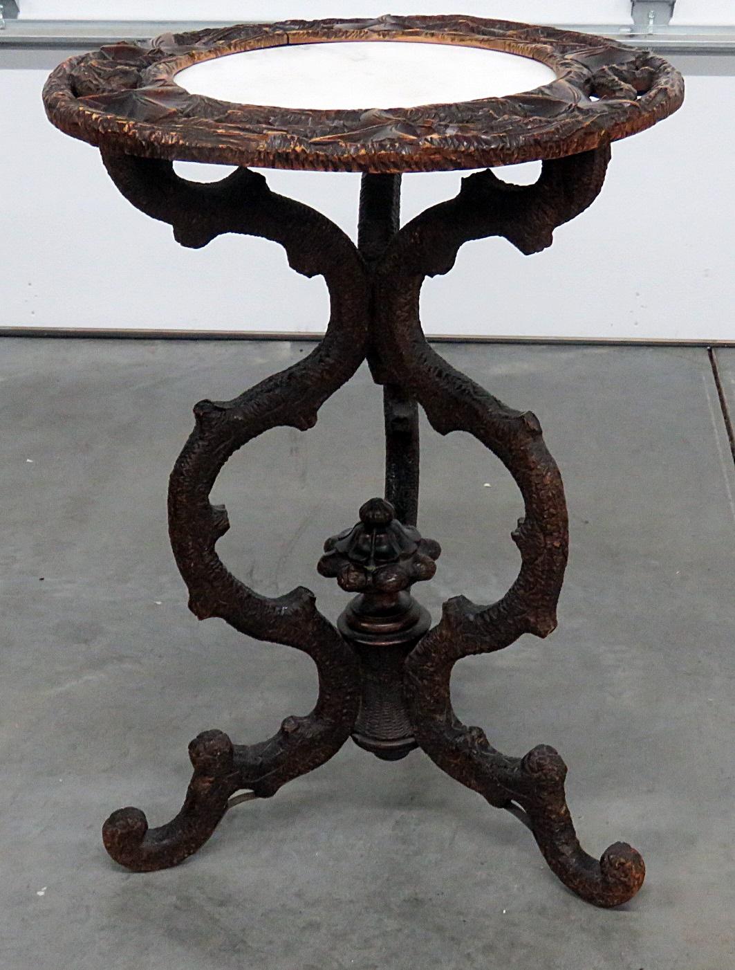 Vintage marble-top, carved center table attributed to forest.