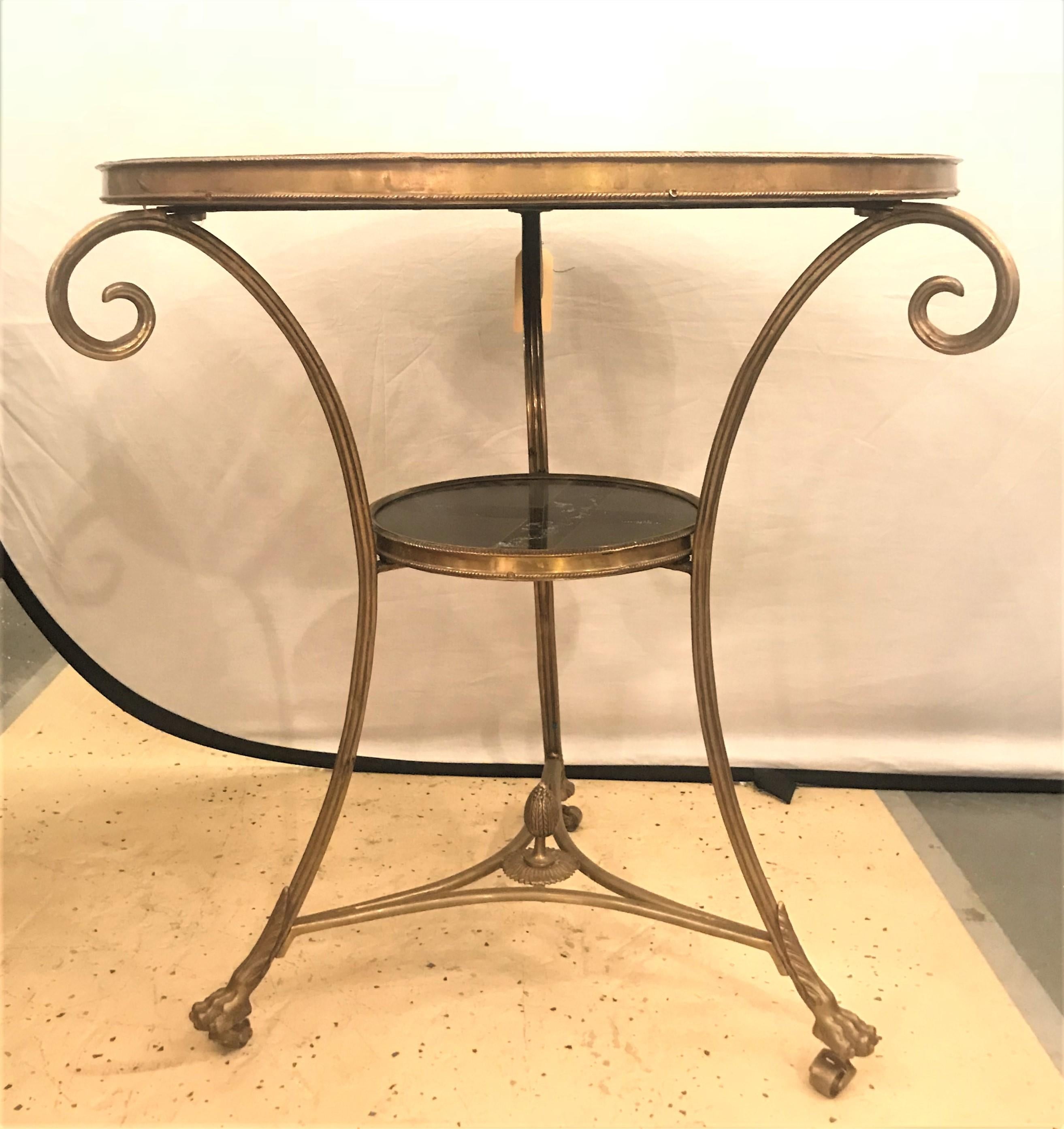 A marble top centre table / gueridon. The base of solid bronze on claw feet with a pineapple support undercarriage having a scroll design with an upper and lower bronze gallery shelf. EXXX