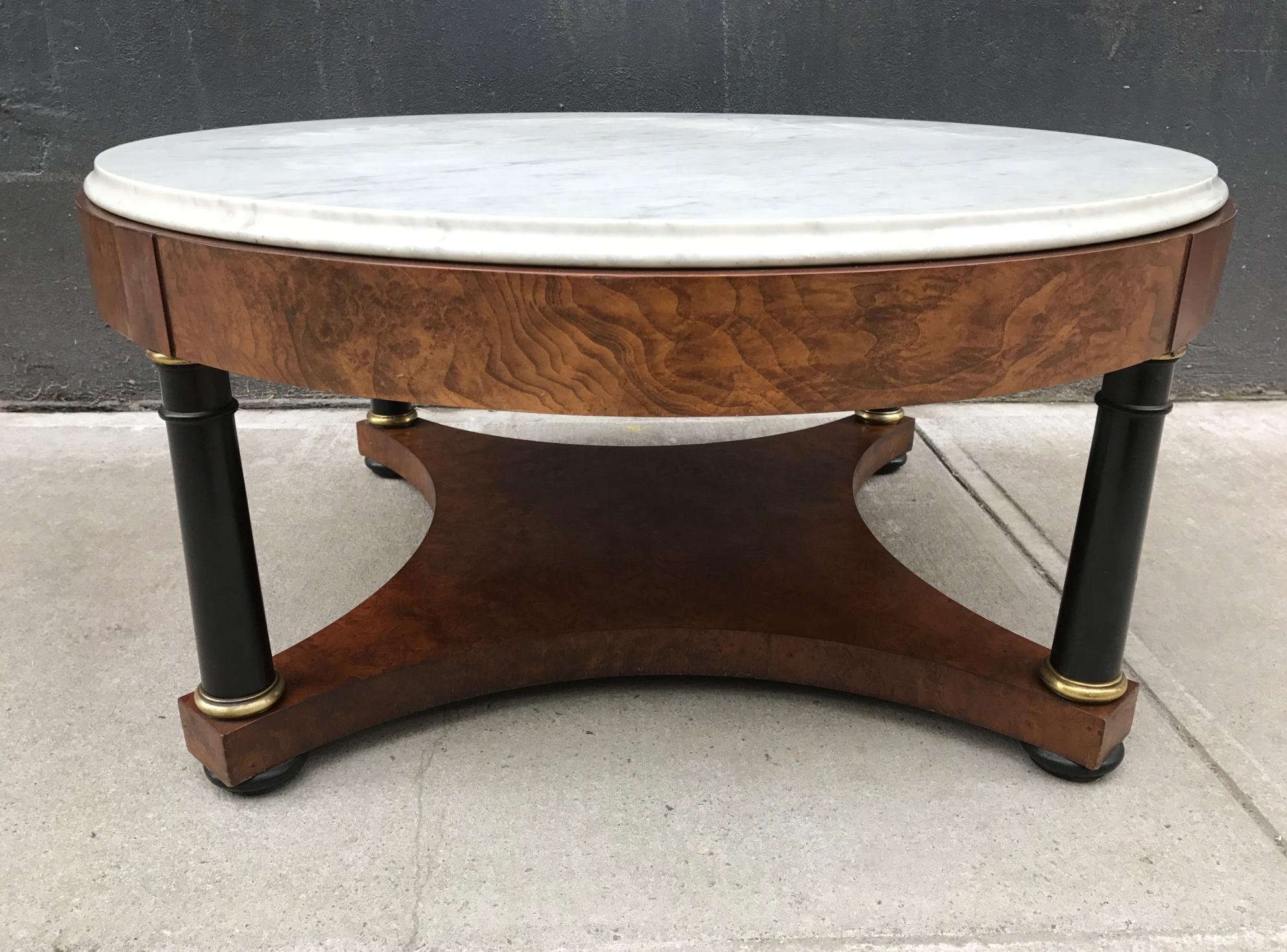 Marble top coffee table by Baker with black lacquered columns and brass trim.
