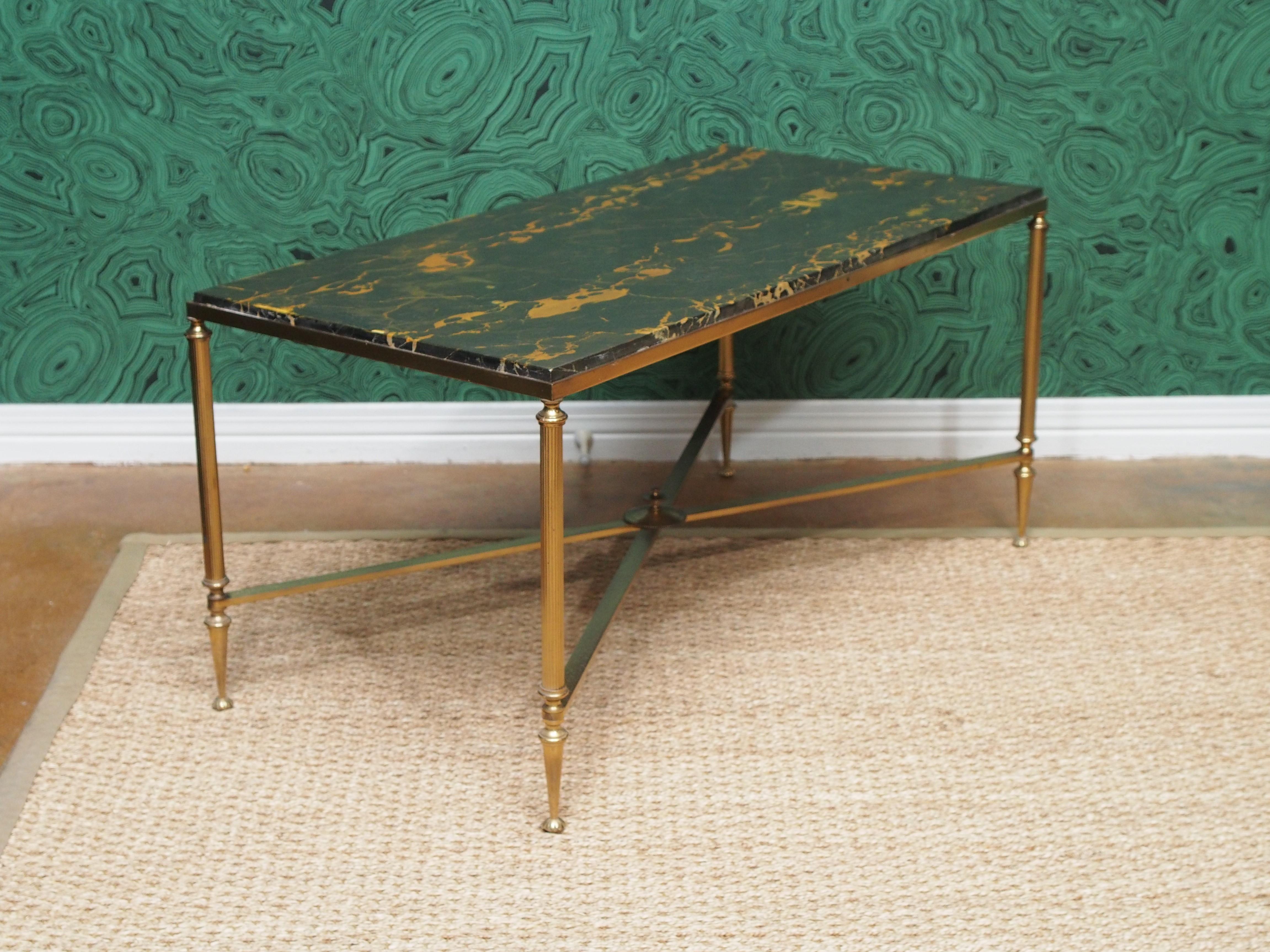 Neoclassical style bronze coffee table having X form stretcher and a marble top.