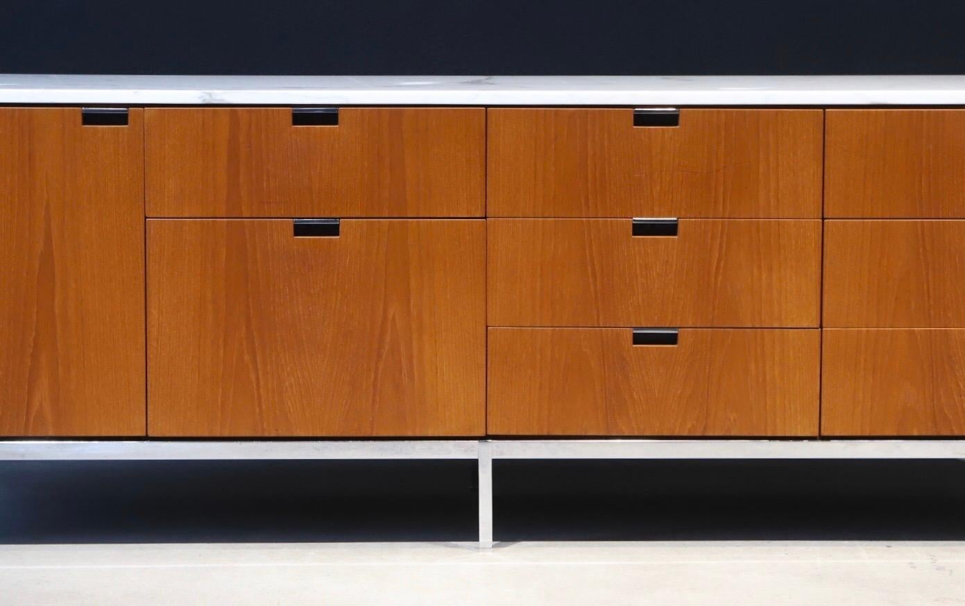 Simplicity in design. A stunning credenza designed by Florence Knoll for Knoll, featuring a marble top and tons of storage. Retains all six square metal leveling glides and pen drawer. Pictured with Harry Bertoia diamond chairs and side chair for