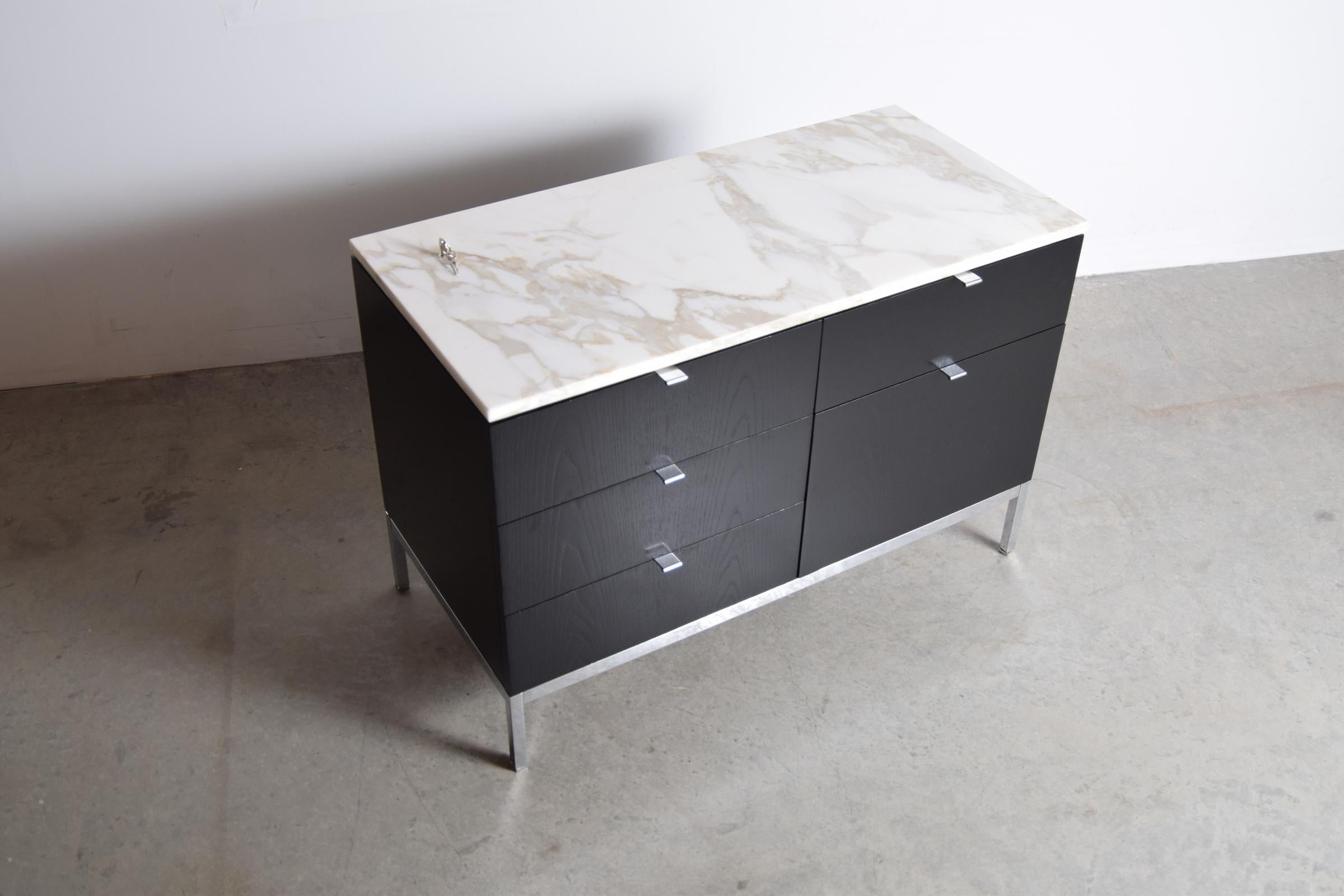 Small ebonized credenza with Calcutta Golden Vein marble top, designed by Florence Knoll, circa 1958. Credenza measures 37 1/4