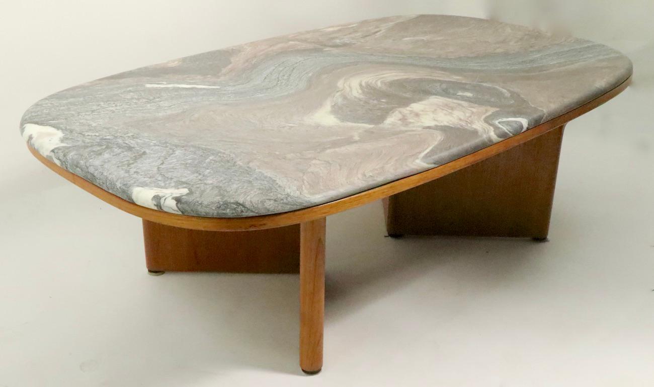 Exceptional swirl marble-top coffee, cocktail table in the Danish Modern taste, made in Sweden by Bendixon. Rounded slab marble top rests of teal]k veneer base. The dramatic organic multi colored patterned stone top, creates a impactful visual