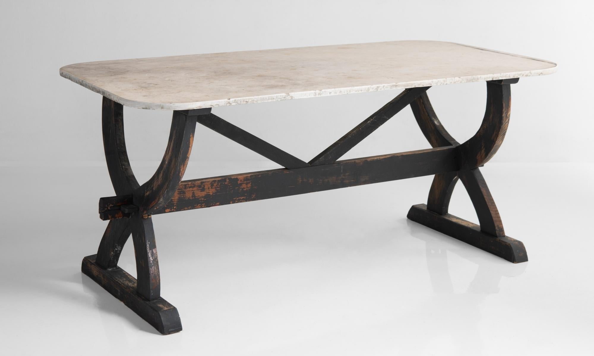 Marble top dining table, France 19th century.

Indoor/outdoor mid-size dining table with curved marble top and painted wooden base.
