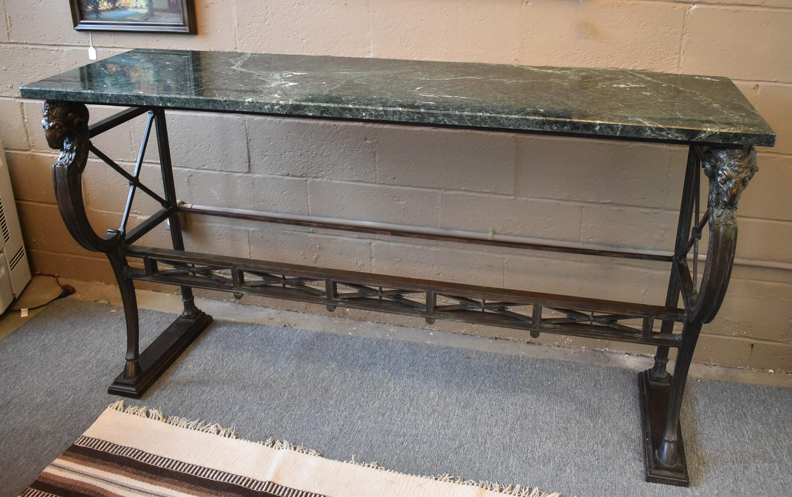 Beautiful French bronze console, server, or hall table with original green marble top, ram's head accents, and hoof feet. Lovely patina. Circa 1910-1920's. 68 1/2