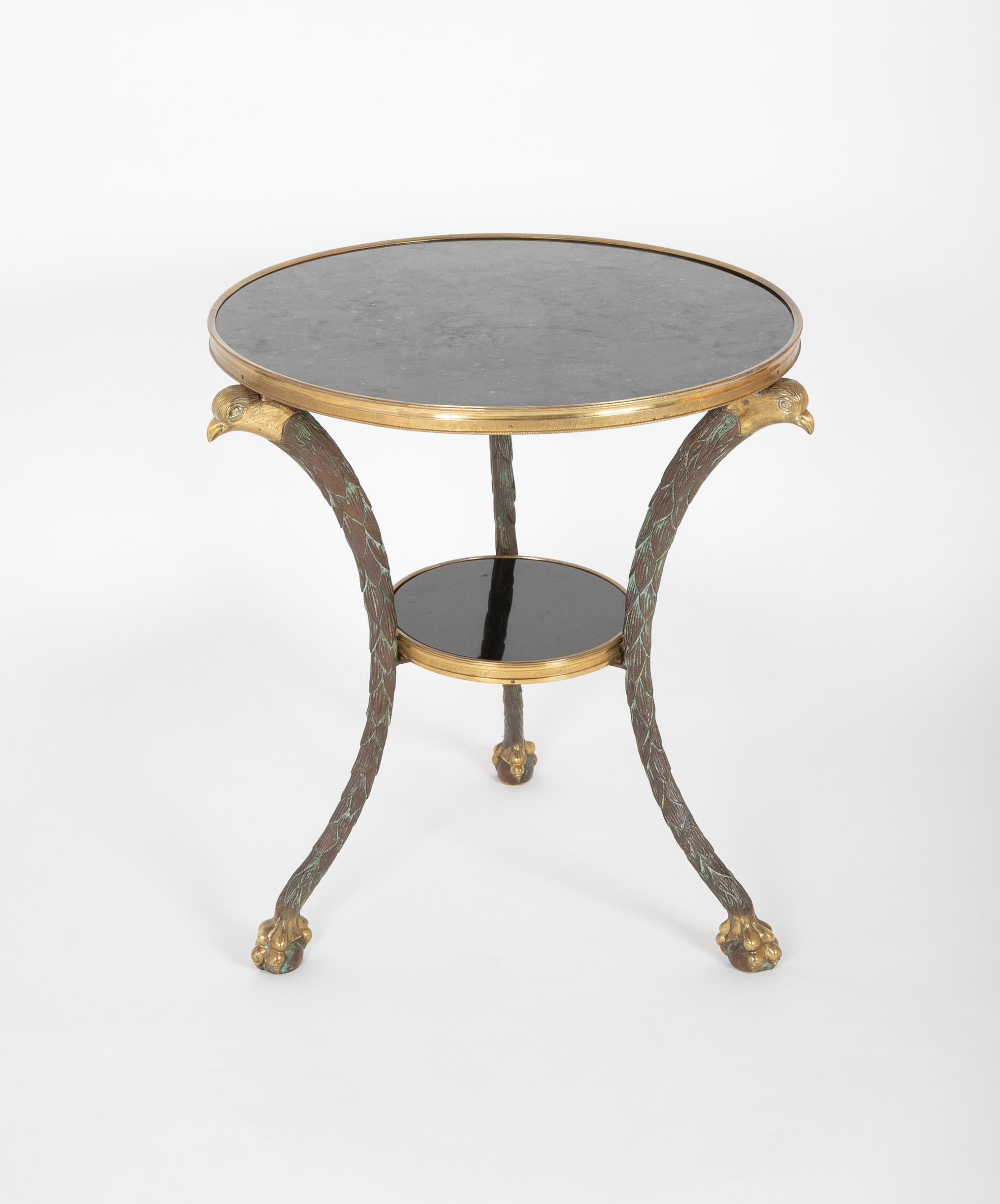 A two-tier marble top gueridon table with interesting form. Presumed to be French.