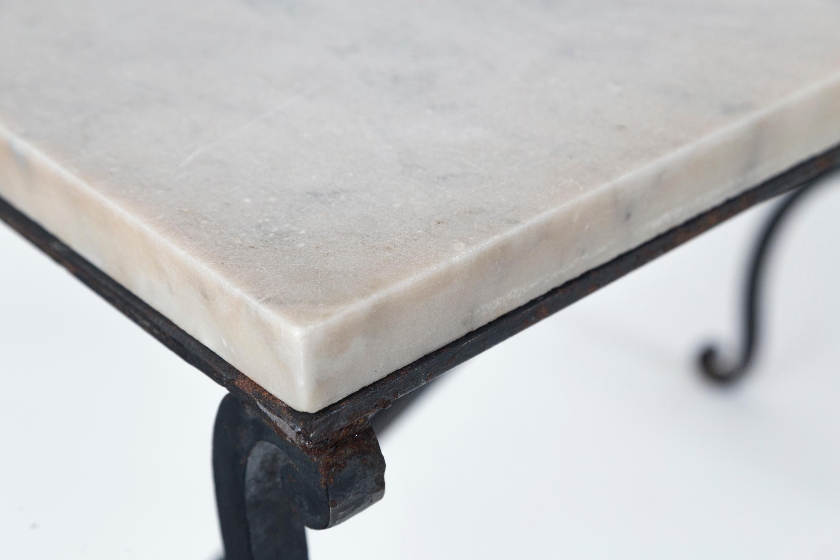 Marble top iron table, France, early 20th century. Original marble top on hand wrought iron base.