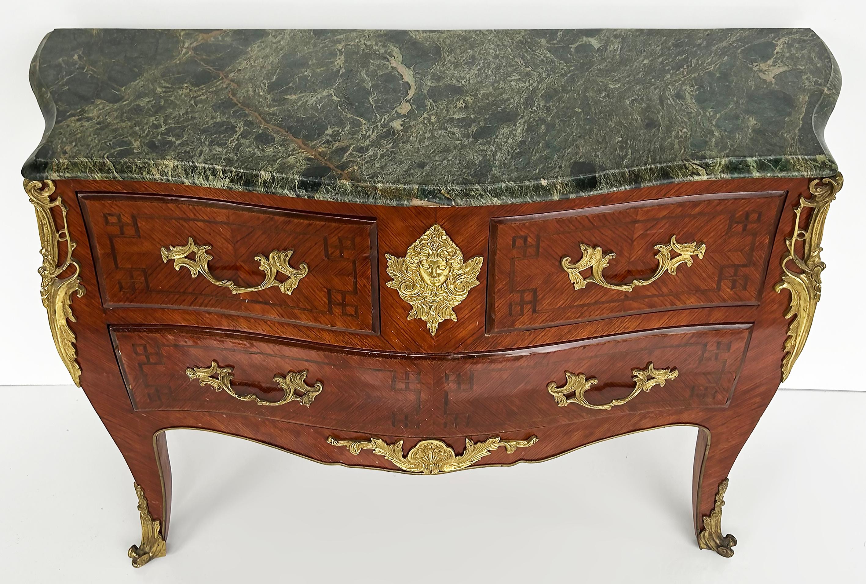Marble Top Three Drawer Commode with Marquetry and Gilt Bronze Mounts, 20th C

Offered for sale is a marble top three-drawer commode with marquetry and gilt bronze hardware and mounts. This elegant late 20th-century commode has a subtle bow front