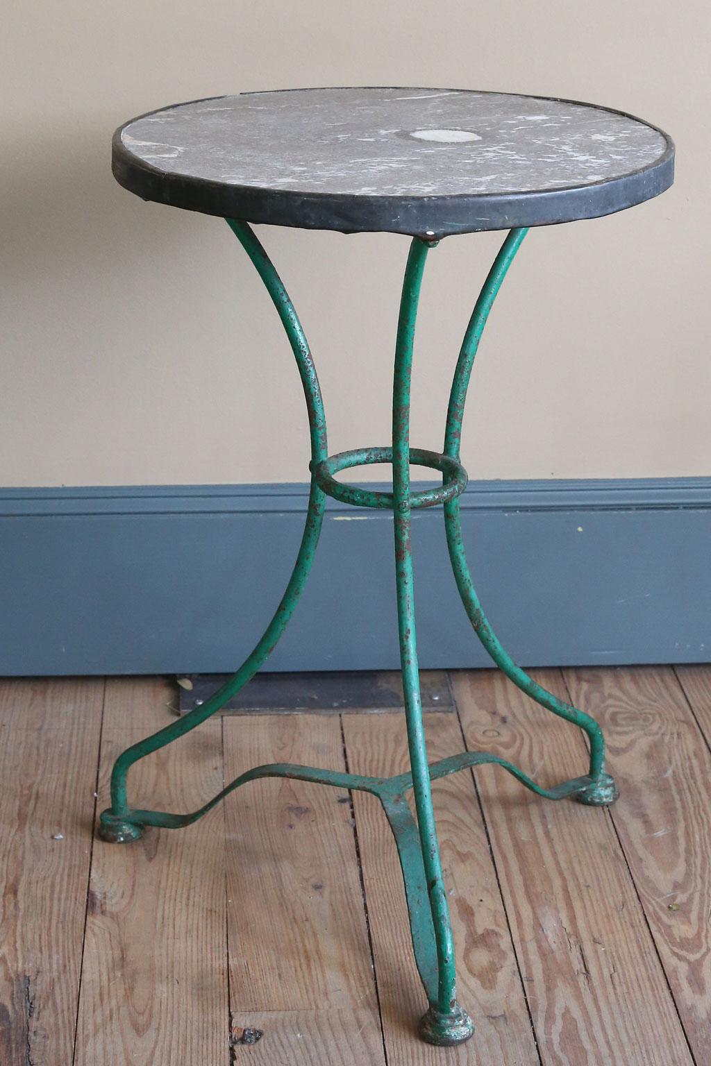 This French table has the most interestingly colored marble top. The iron base has been painted in a past life a green color. The metal banding around the table shows wear. It is original. This versatile table could be used as a small dining table,