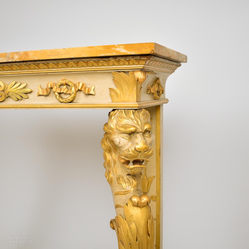 Late 19th century marble-topped console table with carved detailed legs with lions faces in gilt. Gilt and painted detail. circa 1880. An extremely fine decorative item of good height. Perfect for a front hall or porch. Possibly Regency.