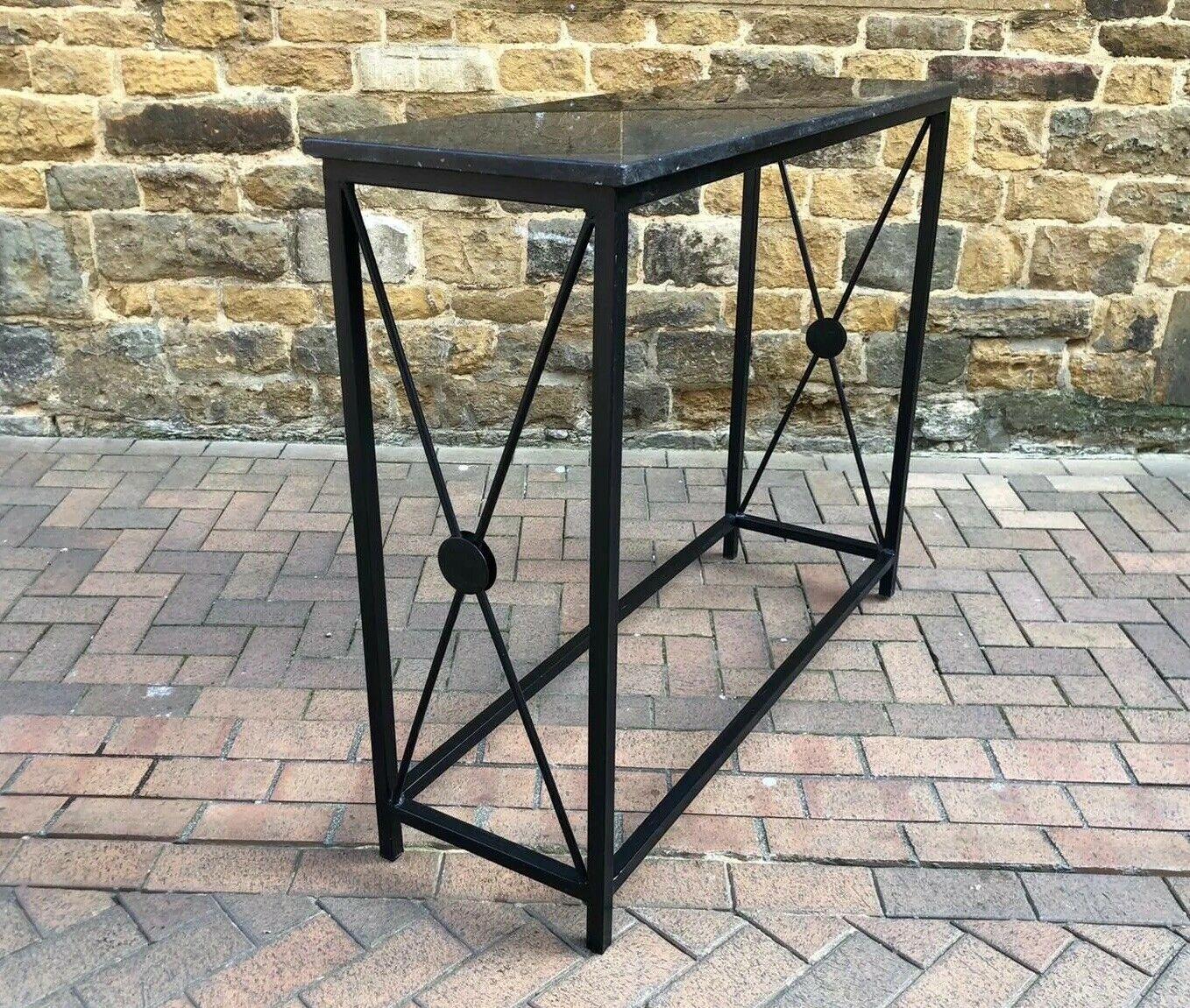This is a beautiful marble-topped console table with a black wrought iron frame.
Very stylish and functional table that would look great in any home.

  