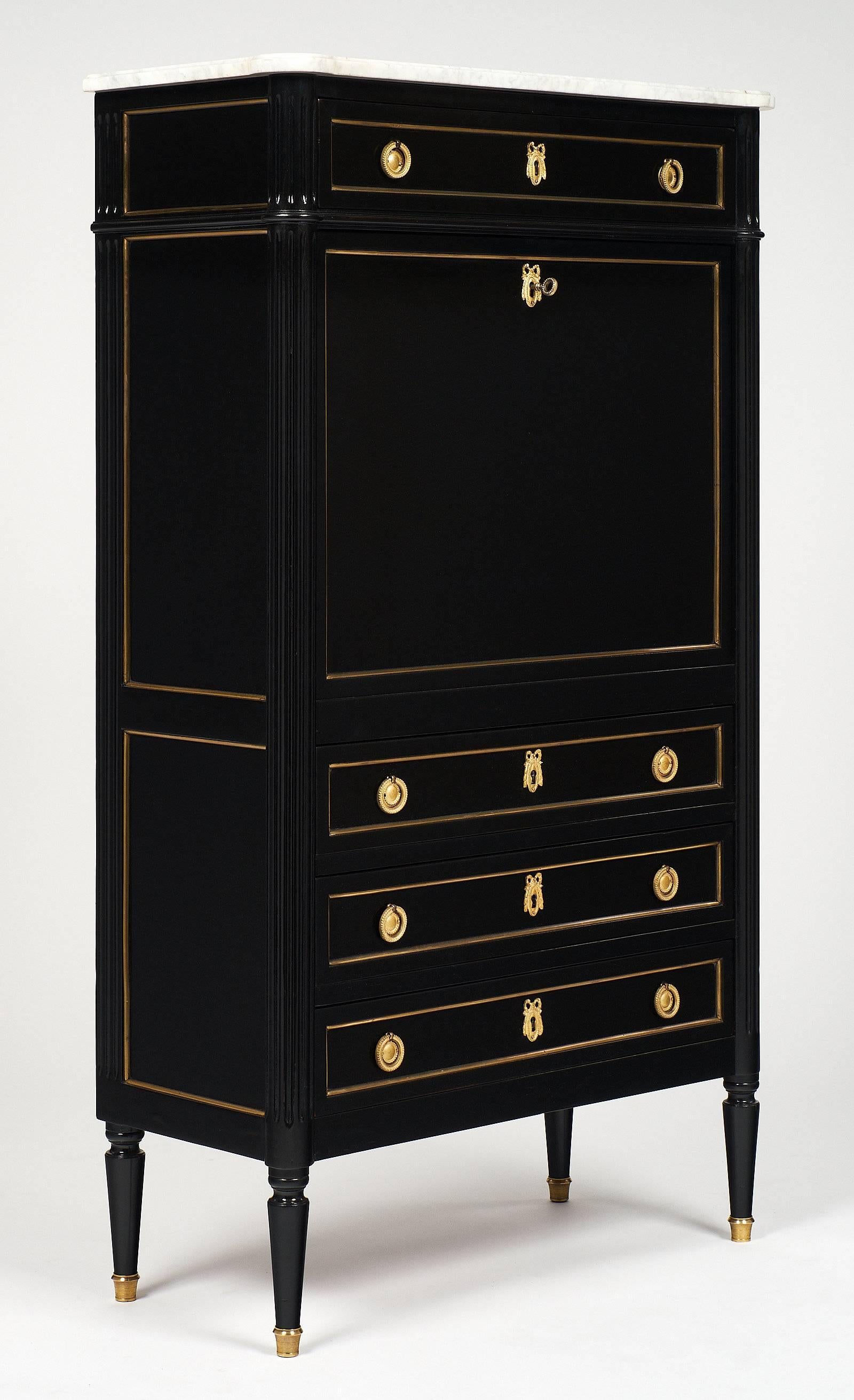 Elegant Louis XVI style French antique secrétaire made of mahogany and topped with an intact Carrara marble slab. This piece is ebonized and finished in a lustrous French polish. The four dovetailed drawers provide ample storage, and the gilt brass