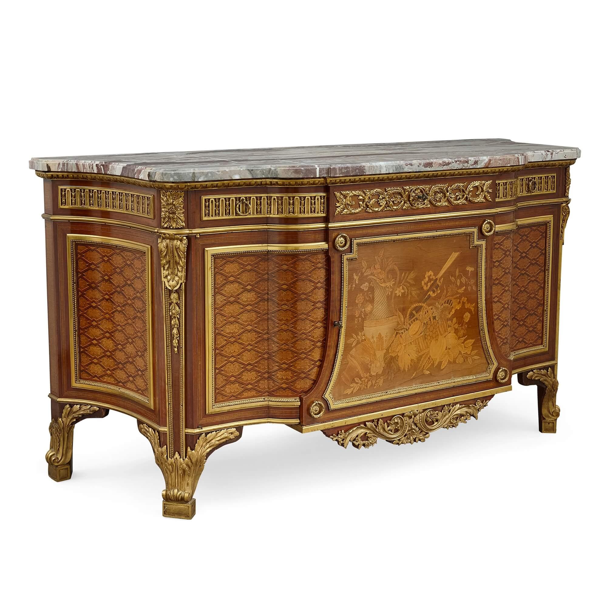 Marble topped marquetry commode after Riesener
French, late 19th Century
Measures: Height 91cm, width 173cm, depth 64cm

This exquisite commode takes after a commode made by the master of 18th Century furniture, Jean-Henri Riesener, which is