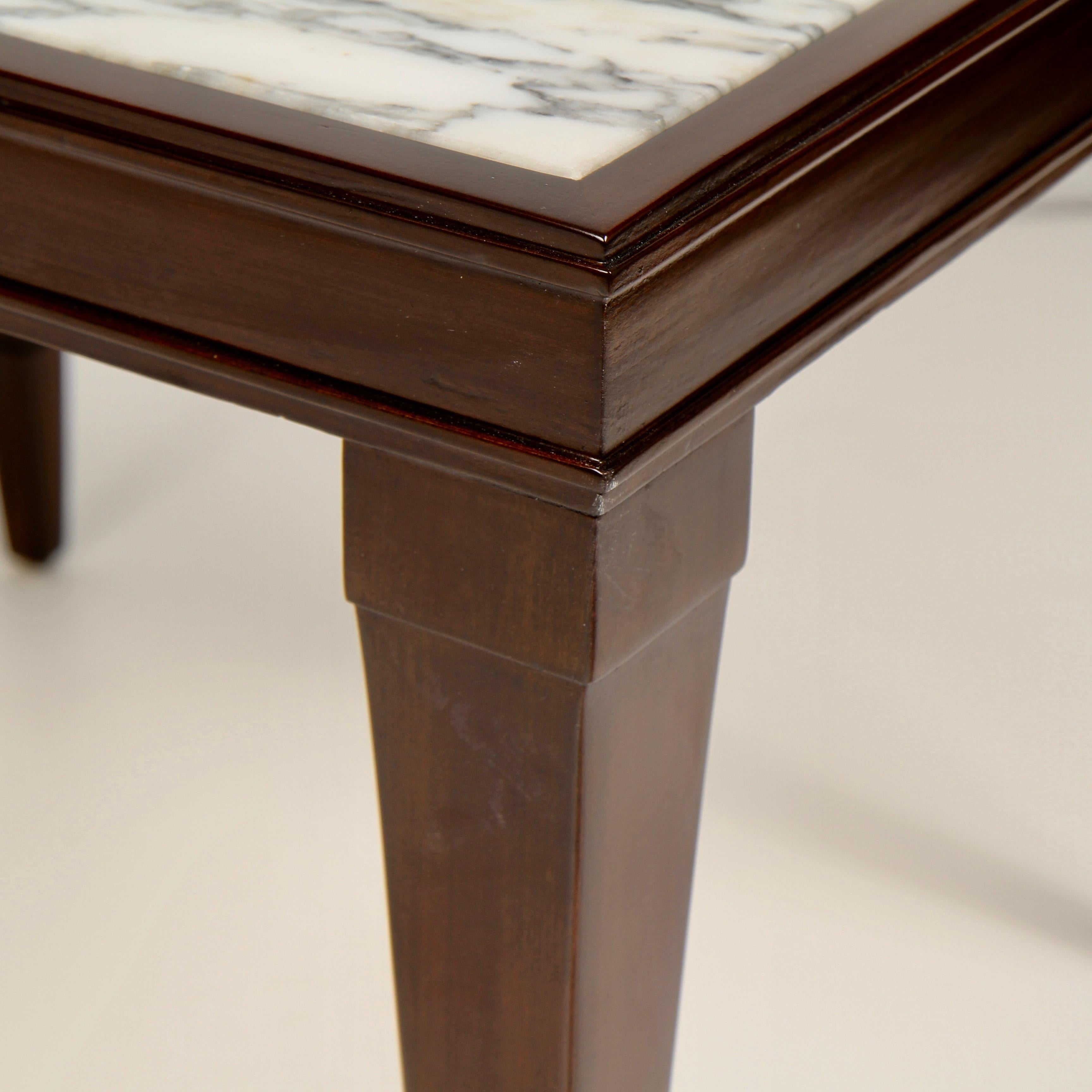1940s era small marble-topped side table in mahogany by the William A. Burkey Furniture Company. In 1950 ownership of the company passed to the John Widdicomb Company.