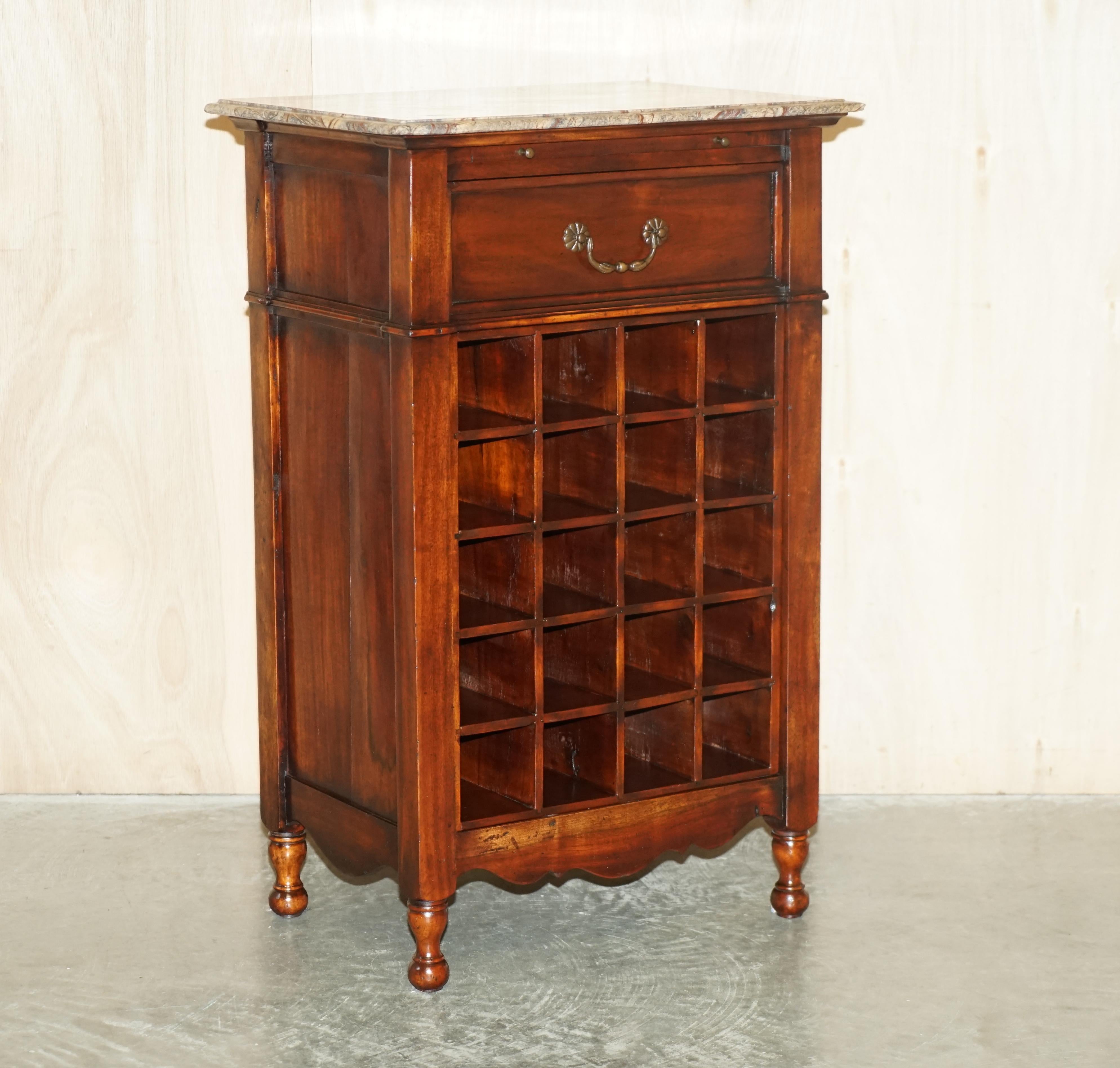 We are delighted to offer for sale this stunning vintage Mahogany Marble topped side table with Butlers serving tray and x20 bottle holders

A very good looking and well-made piece, this piece can hold more than an entire how wine collection, the