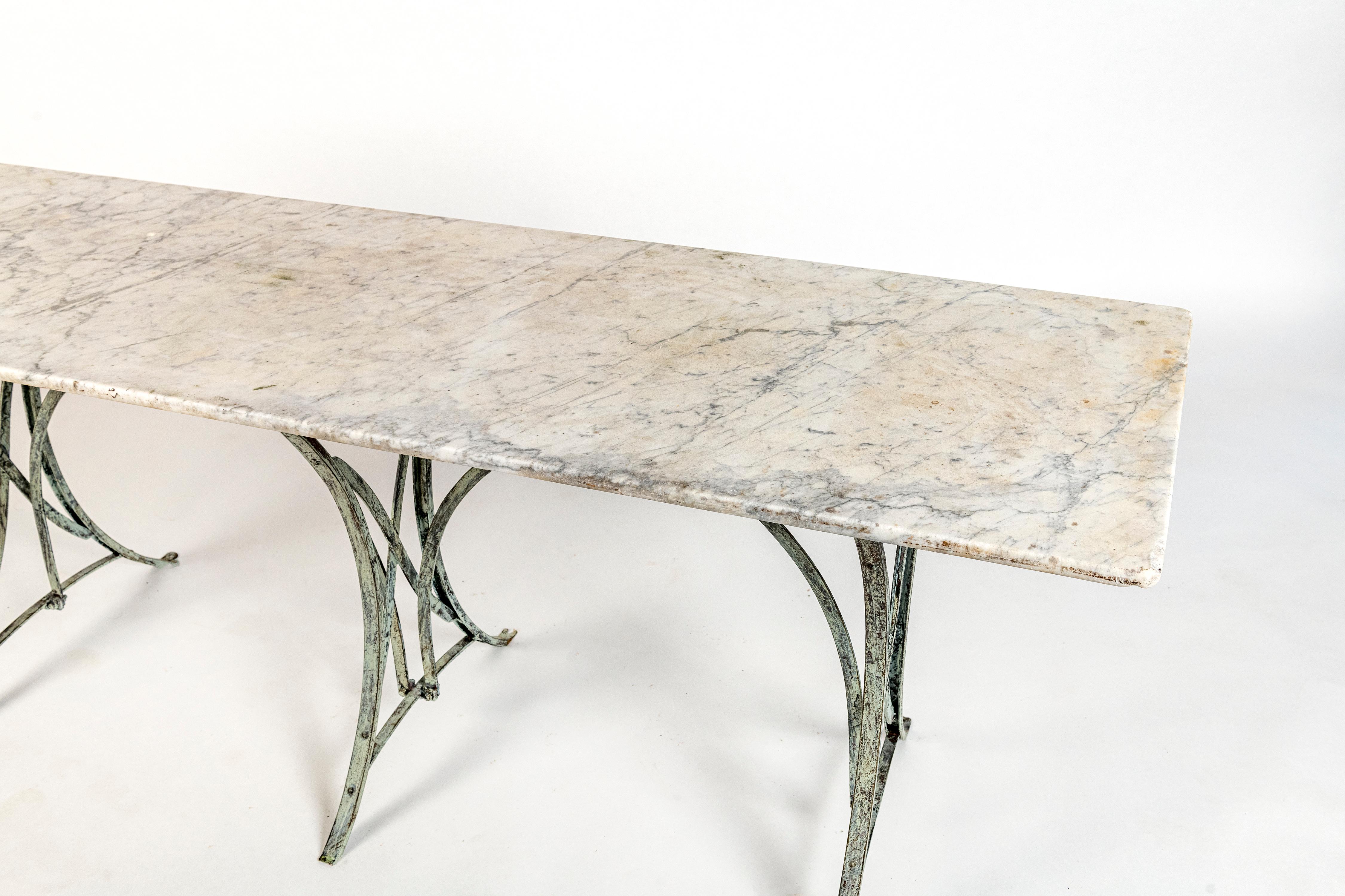 French verdigris wrought iron table base with a beautiful original aged white marble top.  Nice weathered patina.  Perfect for indoor or outdoor use.  
Solid and sturdy.  This piece would work great outdoors in a garden area or patio area or indoors