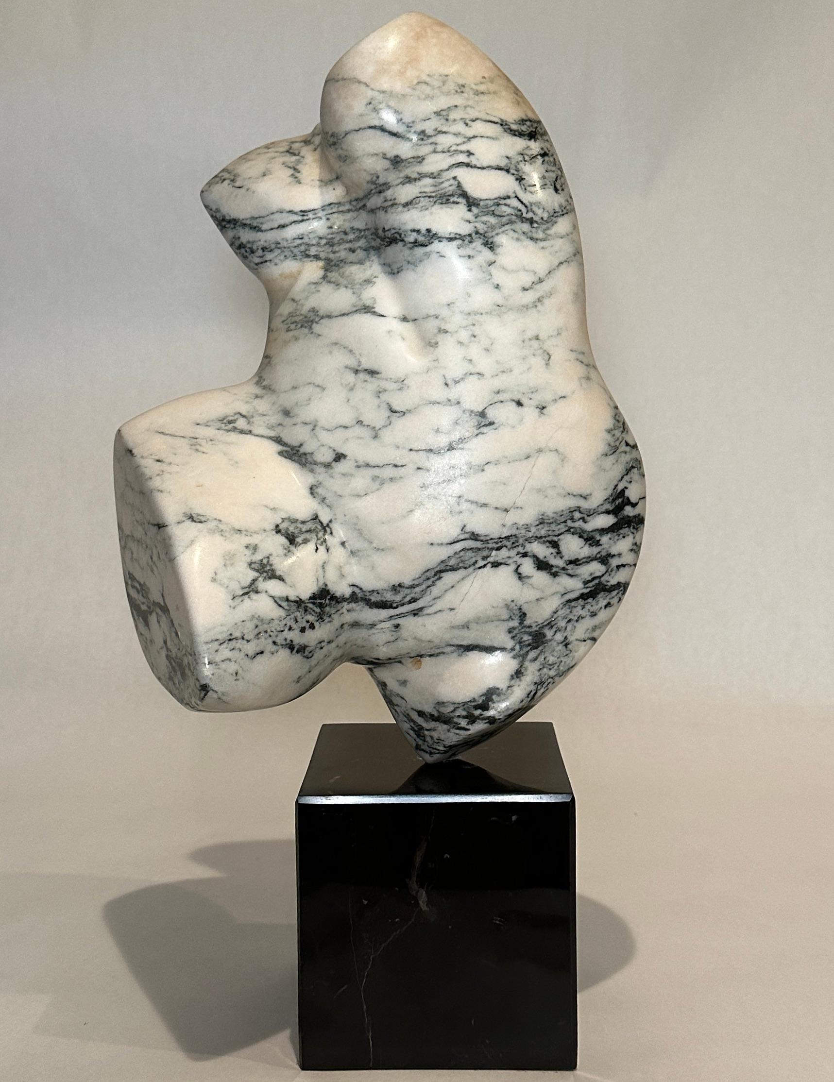 Signed Carved white marble and green sculpture, abstract torso figure that swivels on black marble base by Luis R Cuevas. Contemporary. Born in Utuado, Puerto Rico. Was active and lived in California. A prolific artist who moved to sculpture later