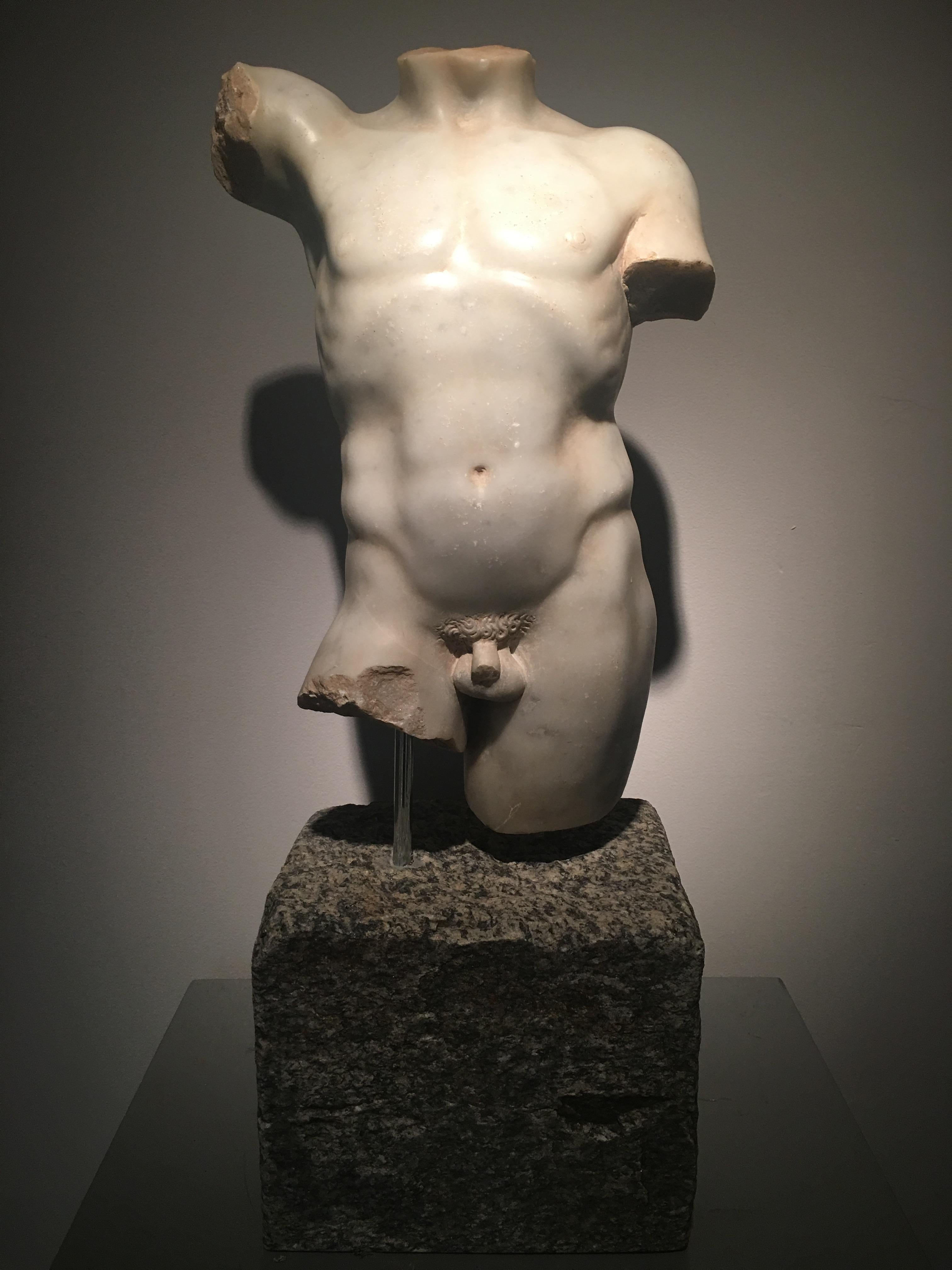 An antique Greek style fragmentary male torso in the Polykleitan tradition, from mid-leg to shoulders, depicting an adolescent male athlete with defined musculature and hairless. He stands contrapposto with the weight on his left leg.

The present