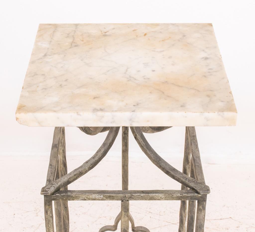 Pedestal plant stand with a white marble top and wrought iron base. 

Dealer: S138XX