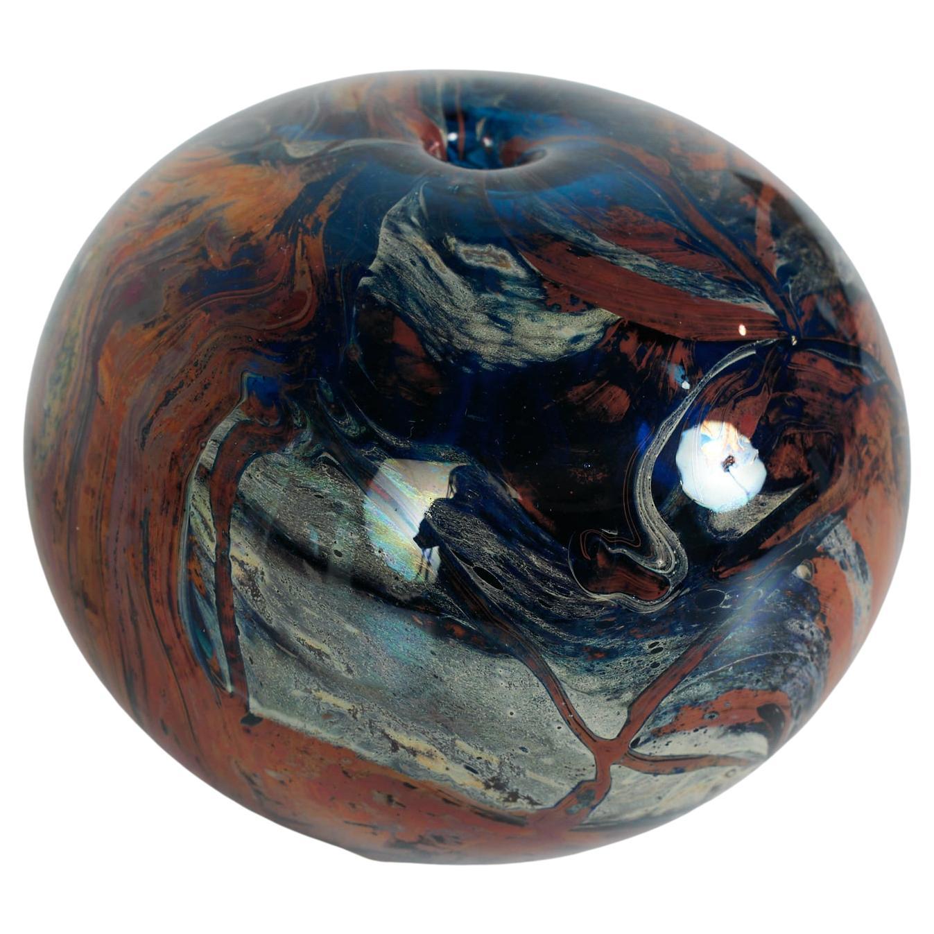 Round bud vase in marbled glass. The vase features a marbled glass in a rich blue, burgundy and cream swirled effect. 

Dimensions:
4