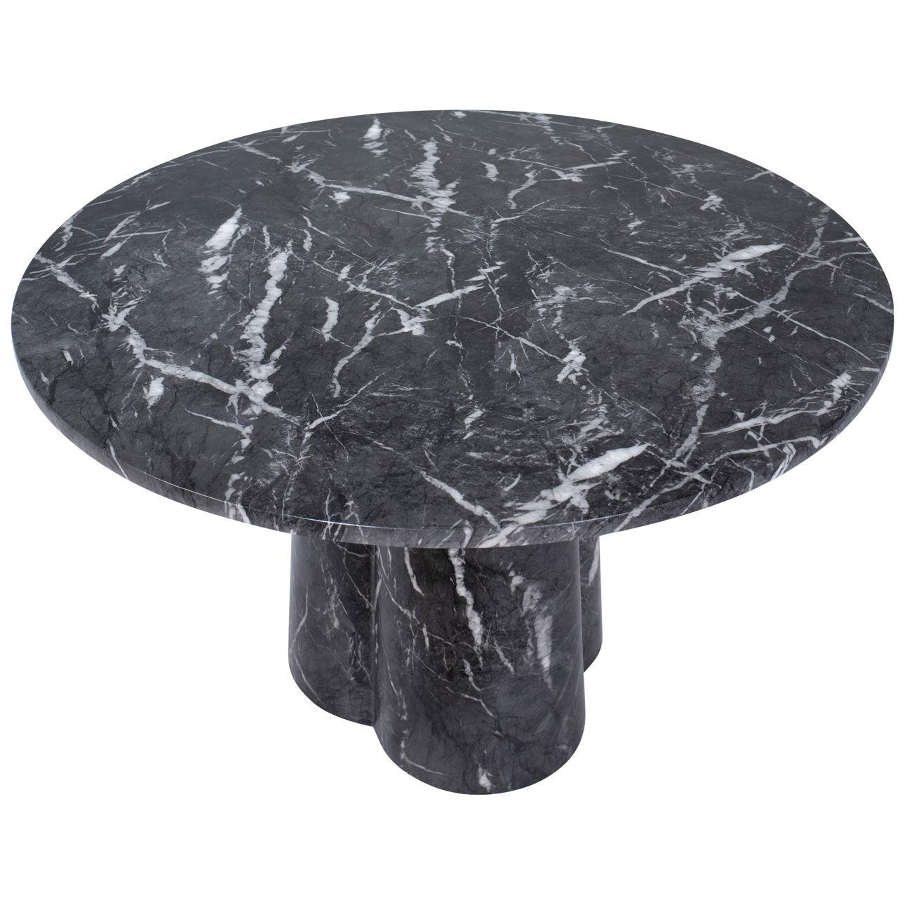 This dining table is crafted with black marble finished on concrete using a water transfer technique that highlights captivating white veins. Its round shape sits elegantly atop a robust pedestal base, combining contemporary aesthetics with