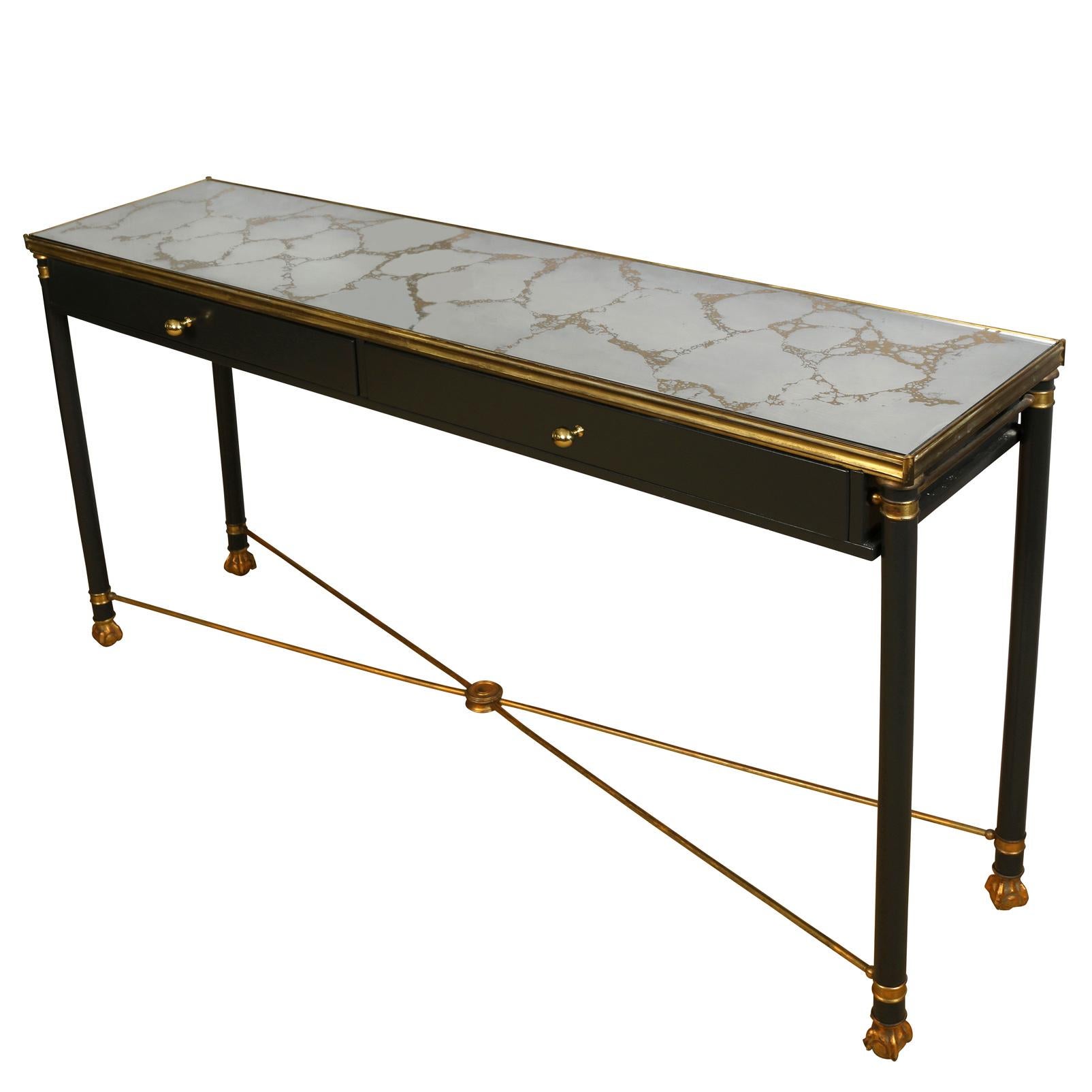 Marbled mirror, Regency style vintage black console with gilt details, gilt X stretcher to straight legs with claw and ball feet, and two drawers for storage.