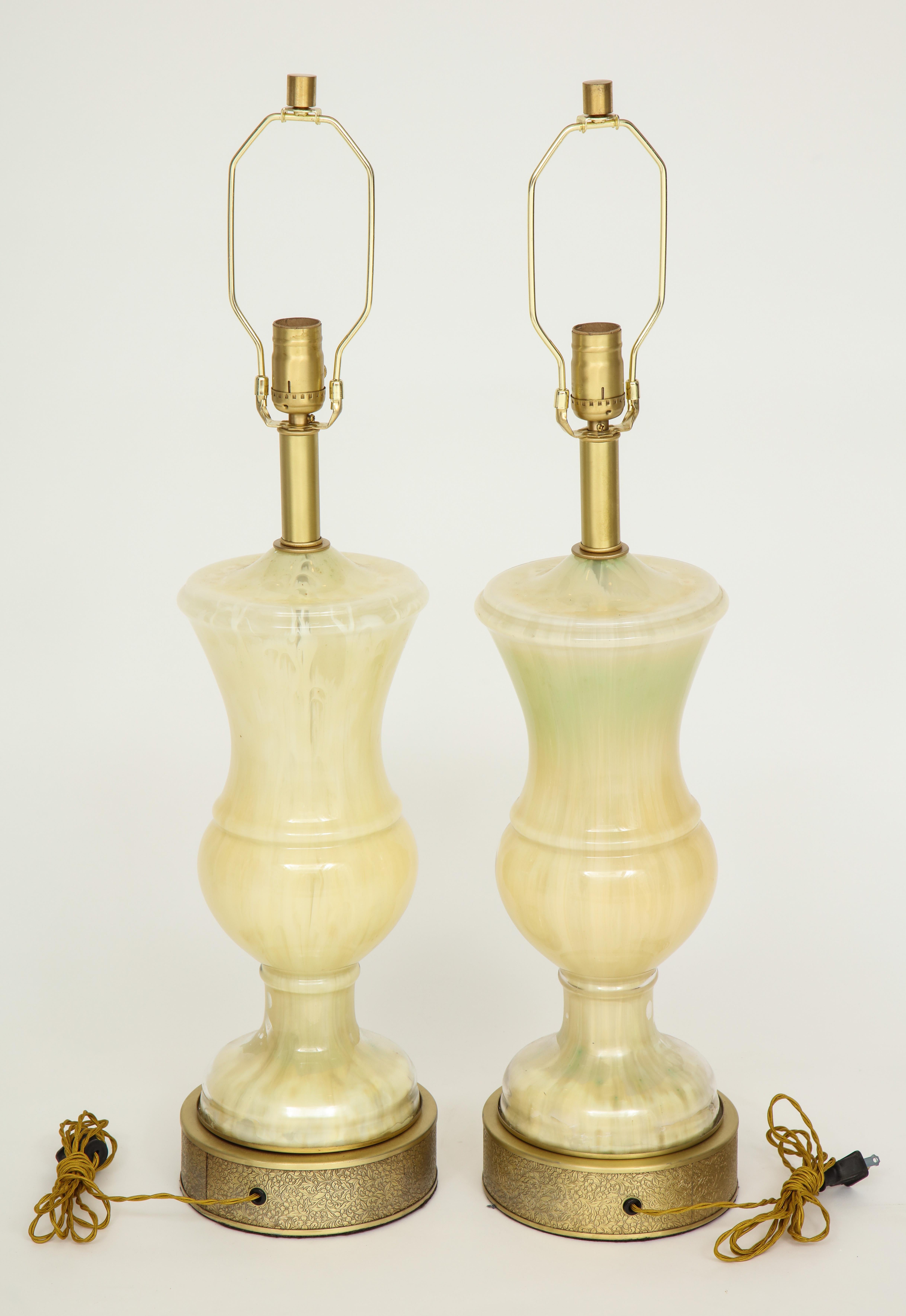 Pair of classical urn form Murano glass lamps in tones of cream and white on etched brass bases. Rewired for use in the USA. 100 W max. Glass body measures 17.5 inches tall.