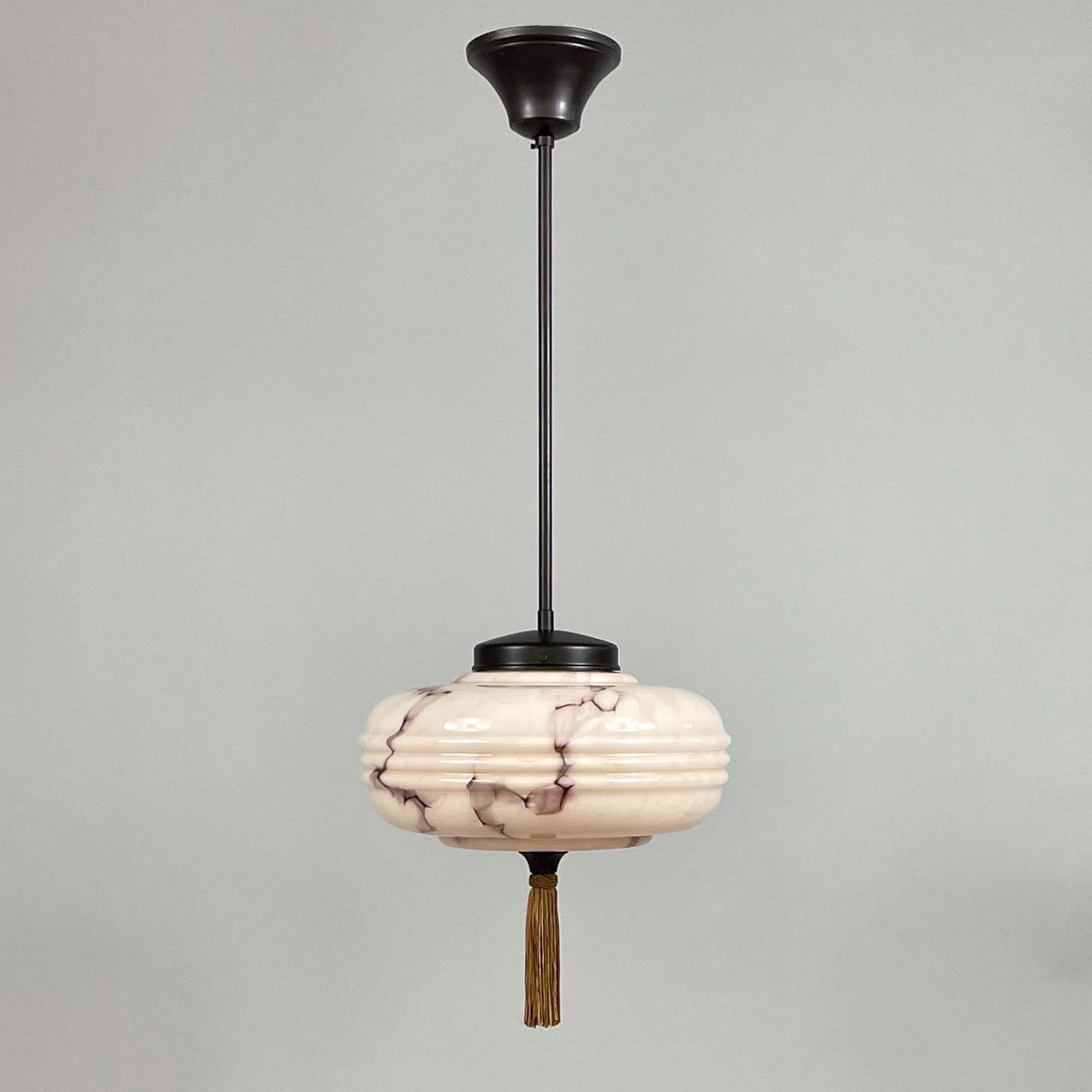 This elegant Pendant was designed and manufactured in Germany during the Bauhaus Period. 

It features a striking Art Deco design from 1930s Germany, characterized by its softly rounded, tiered opaline glass shade with a marbled pale rose and brown
