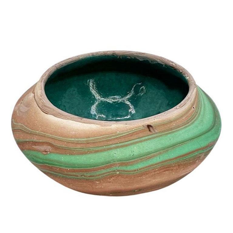 A petite small clay roadside decorative touring bowl. This catchall or dish is short, and wide, and decorated with a malachite look green marbled design on the exterior. The inside is glazed in deep verdigris or turquoise. A lovely piece of