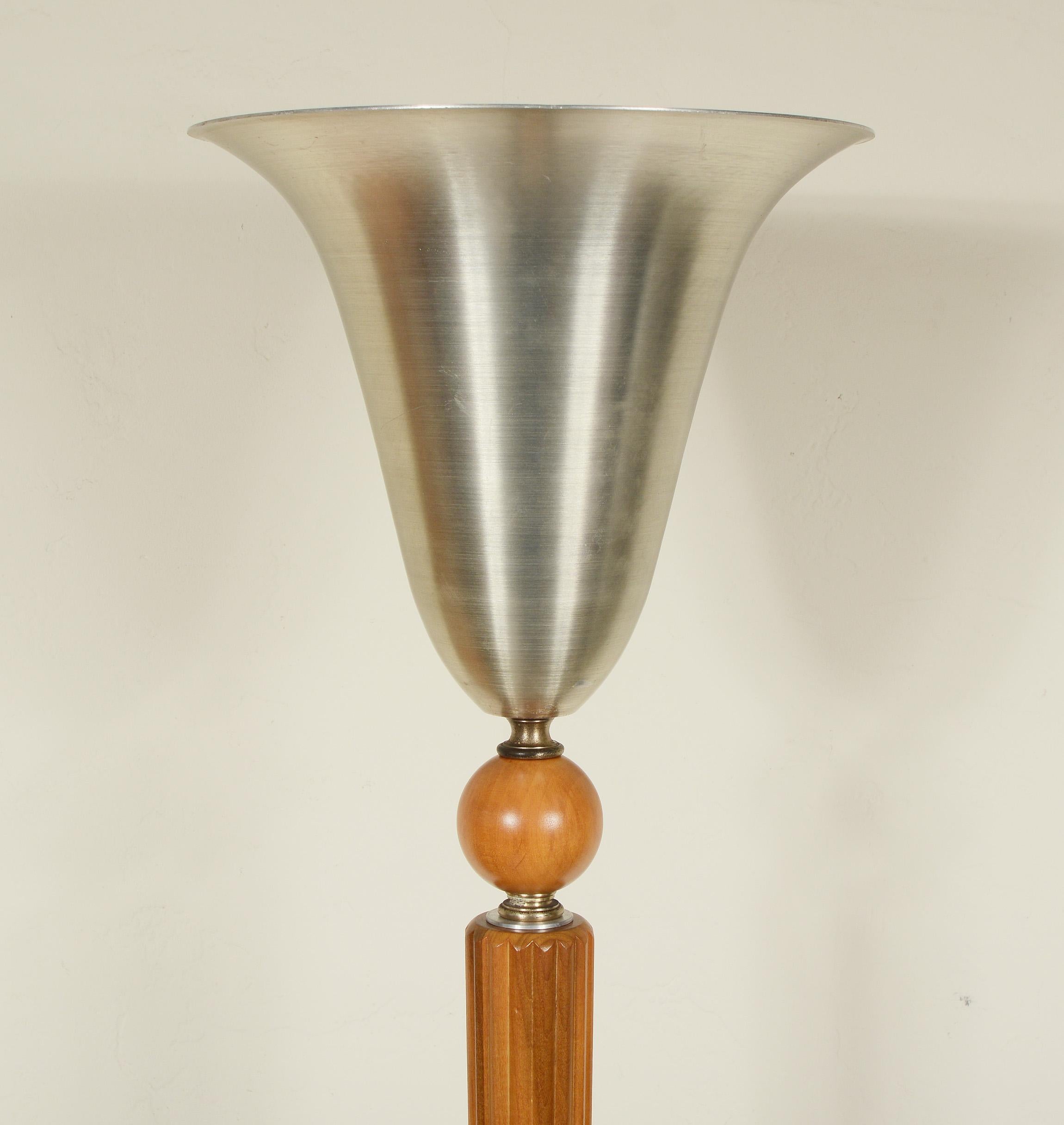 Moderne Art Deco torchiere by Marbro Lamp Co. This lamp has a ribbed wood column with an aluminum shade and base. The lamp has a three way mogul socket. The wood is refinished and it has been rewired with brown twisted rayon cord. The aluminum shows
