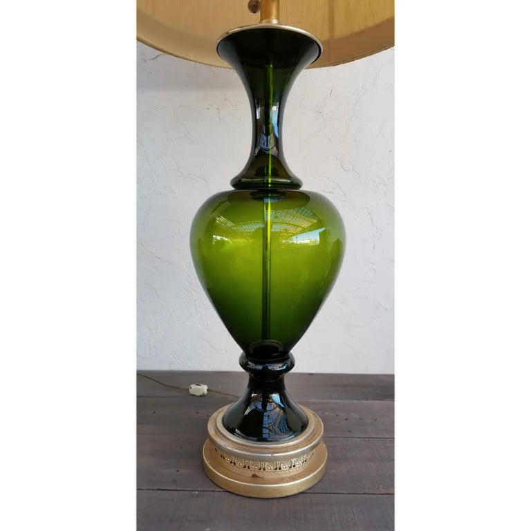 A Marbro turned green glass table lamp retaining its original lamp shade with Greek key design. Excellent original condition. Base measures 7' diameter.

Marbro Lamp Company
The company was founded by Morris Markoff and his brother, hence the