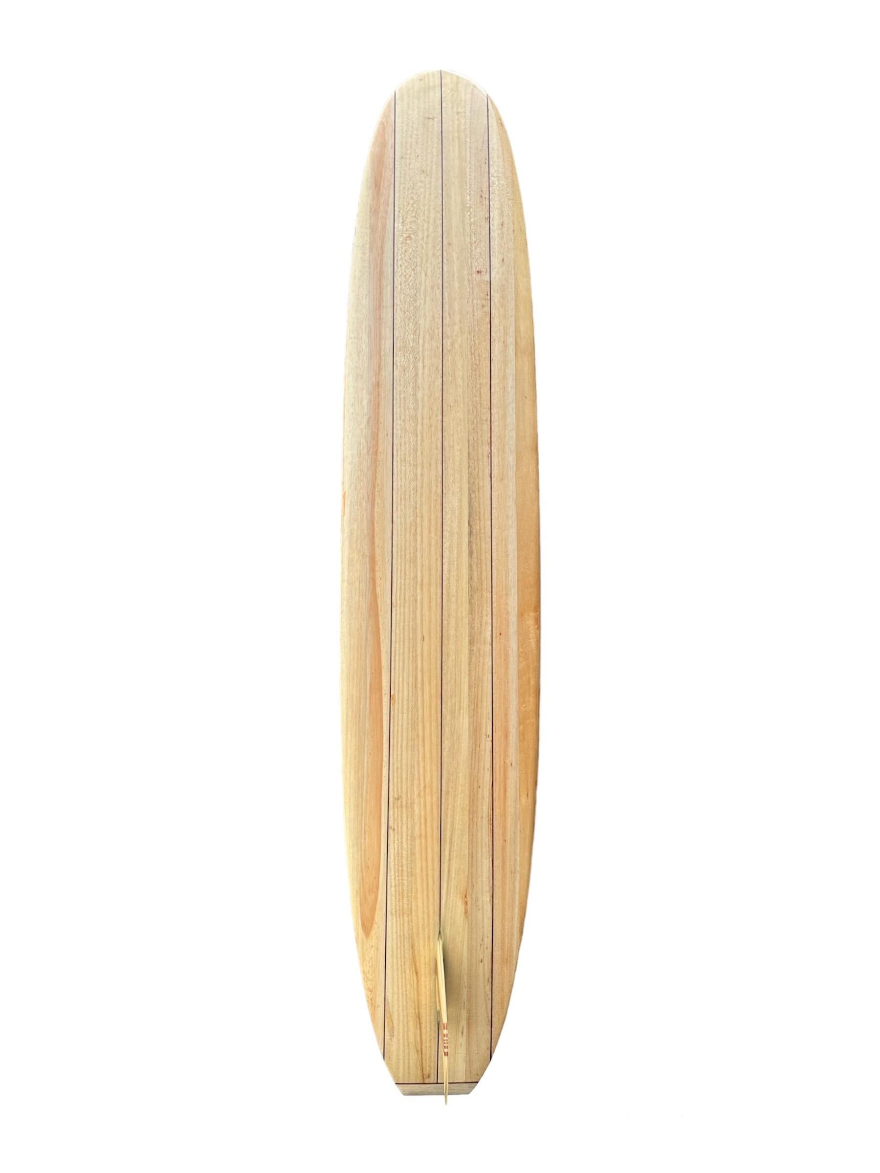 Marc Andreini shaped balsa wooden longboard. Features a classic longboard shape design with triple stringers and striking 13 piece wood fin. A remarkable example of a beautifully hand crafted balsawood longboard.