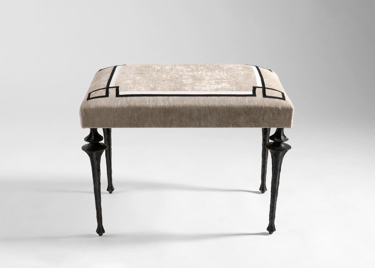 The Mekong Bench features a set of newly designed legs by Marc Bankowsky in patinated bronze. The plush seat is upholstered in fabric embroidered by the Chilean-born Miguel Cisterna, whose work imbues the classical French tradition of fine