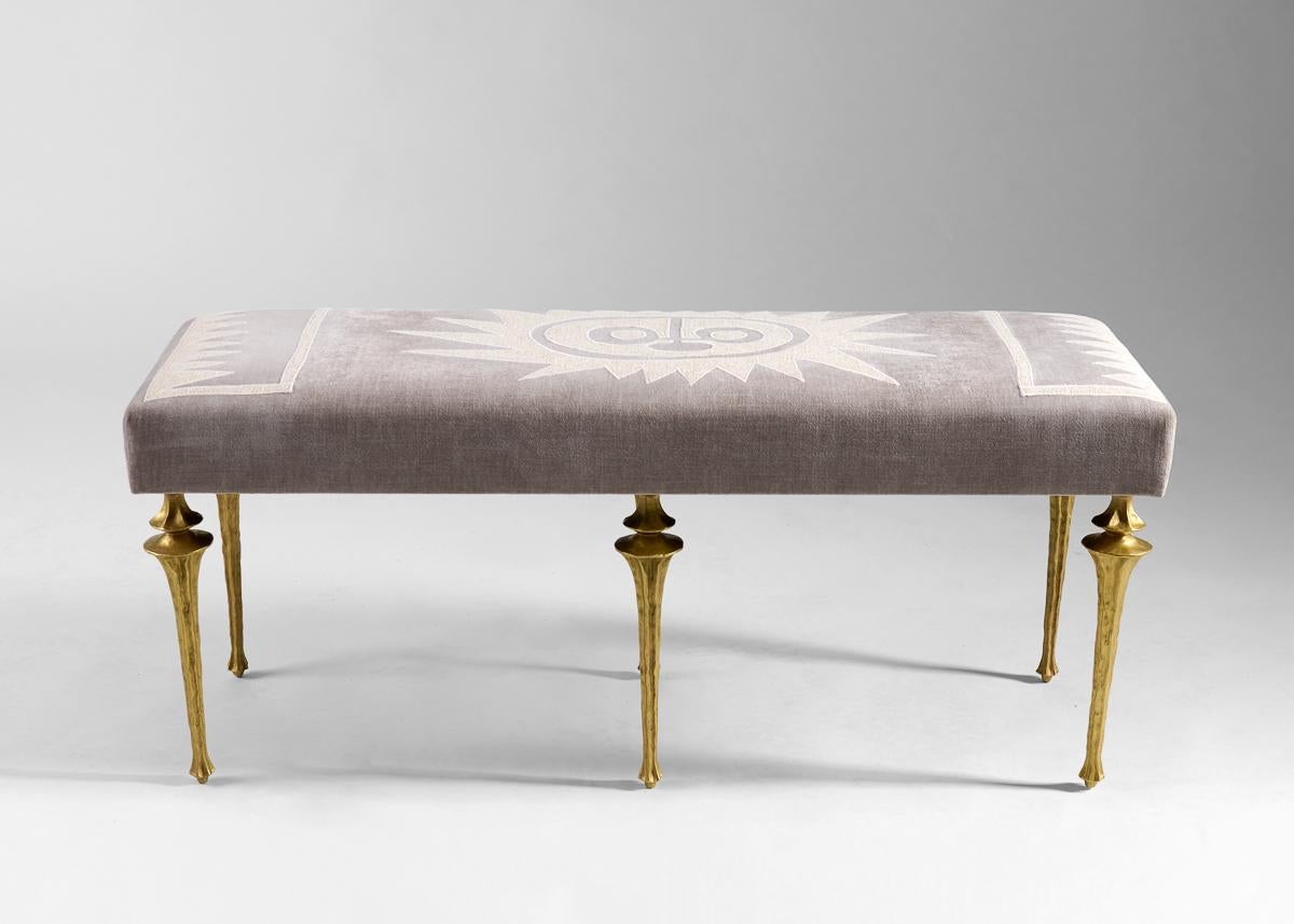 This long Nijinksy bench features a set of eight newly designed legs by Marc Bankowsky in gold patinated bronze. The plush seat is upholstered in fabric embroidered by the Chilean-born Miguel Cisterna, whose work imbues the classical French