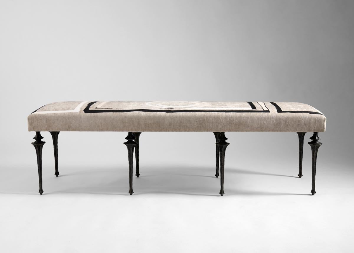 Ce banc Nijinksy extra-long est doté d'un ensemble de huit pieds nouvellement conçus par Marc Bankowsky en bronze patiné. L'assise moelleuse est recouverte d'un tissu brodé par Miguel Cisterna, originaire du Chili, dont le travail s'inspire de la